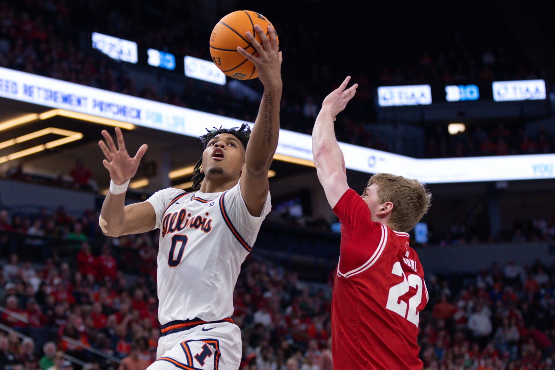 MINNEAPOLIS, MN - MARCH 17: Illinois Fighting Illini guard Terrence Shannon Jr. (0) goes up for a shot over Wisconsin Badgers forward Steven Crowl (22) during the first half of the Big Ten Men's Basketball Tournament championship game between the Wisconsin Badgers and Illinois Fighting Illini on March 17, 2024, at the the Target Center in Minneapolis, MN. (Photo by Bailey Hillesheim/Icon Sportswire via Getty Images)