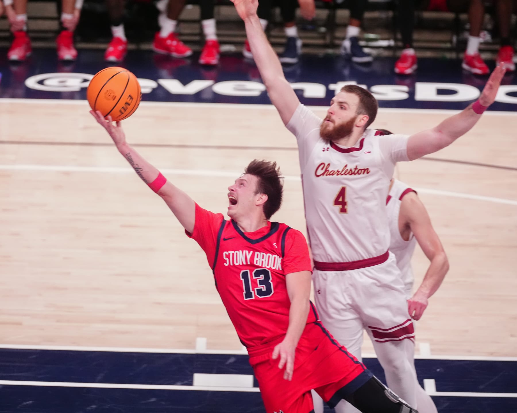 WASHINGTON, DC - MARCH 12: Stony Brook Seawolves Guard Dean Noll (13) shoots a layup against Charleston Cougars Guard Bryce Butler (4) during the second half of the CAA Men's Basketball Championship game between the Stony Brook Seawolves and the Charleston Cougars on March 12, 2024, at the Entertainment & Sports Arena in Washington DC. (Photo by Gregory Fisher/Icon Sportswire via Getty Images)