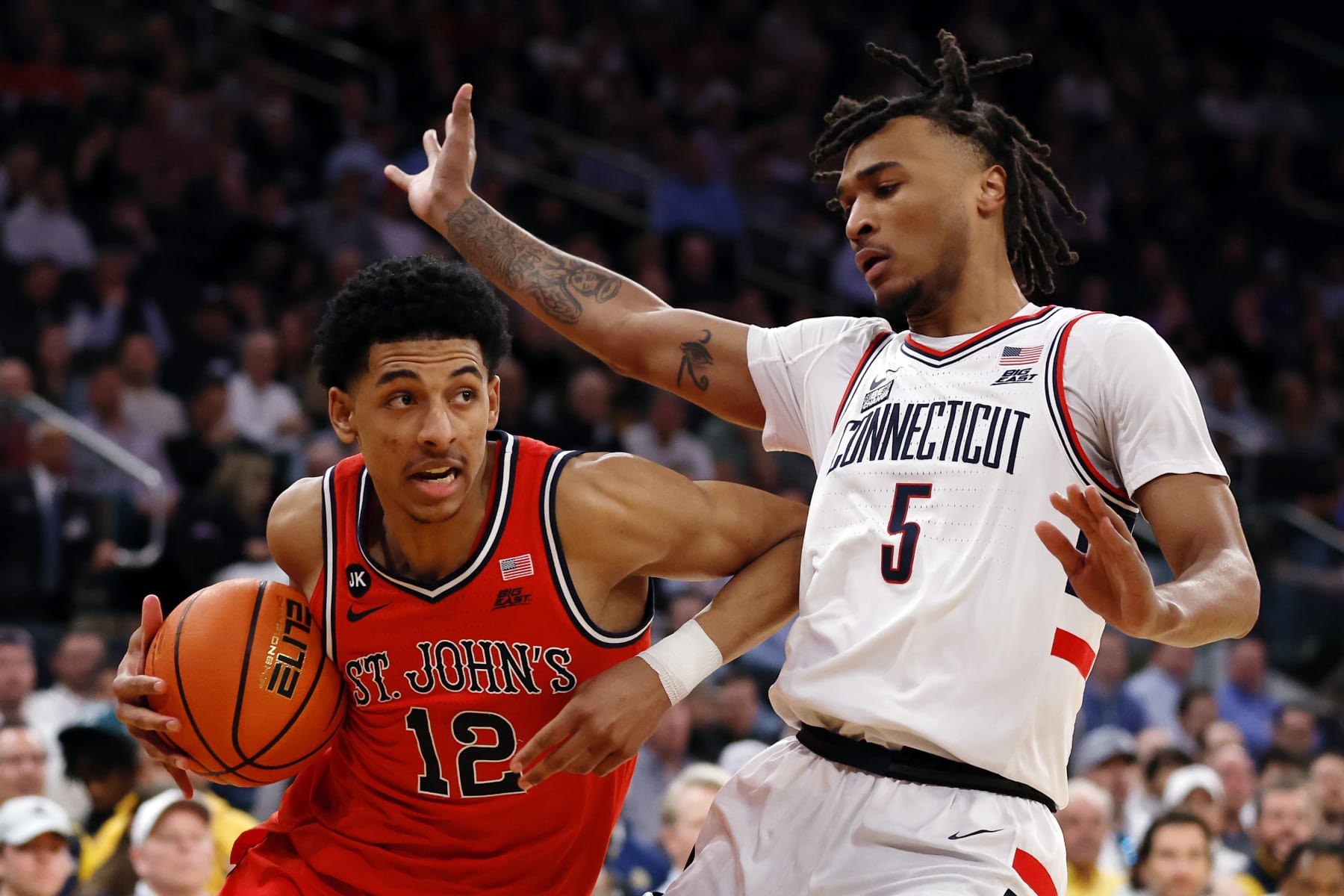 NEW YORK, NEW YORK - MARCH 15: Stephon Castle #5 of the Connecticut Huskies guards RJ Luis Jr. #12 of the St. John's Red Storm in the first half during the Semifinal round of the Big East Basketball Tournament at Madison Square Garden on March 15, 2024 in New York City. (Photo by Sarah Stier/Getty Images)