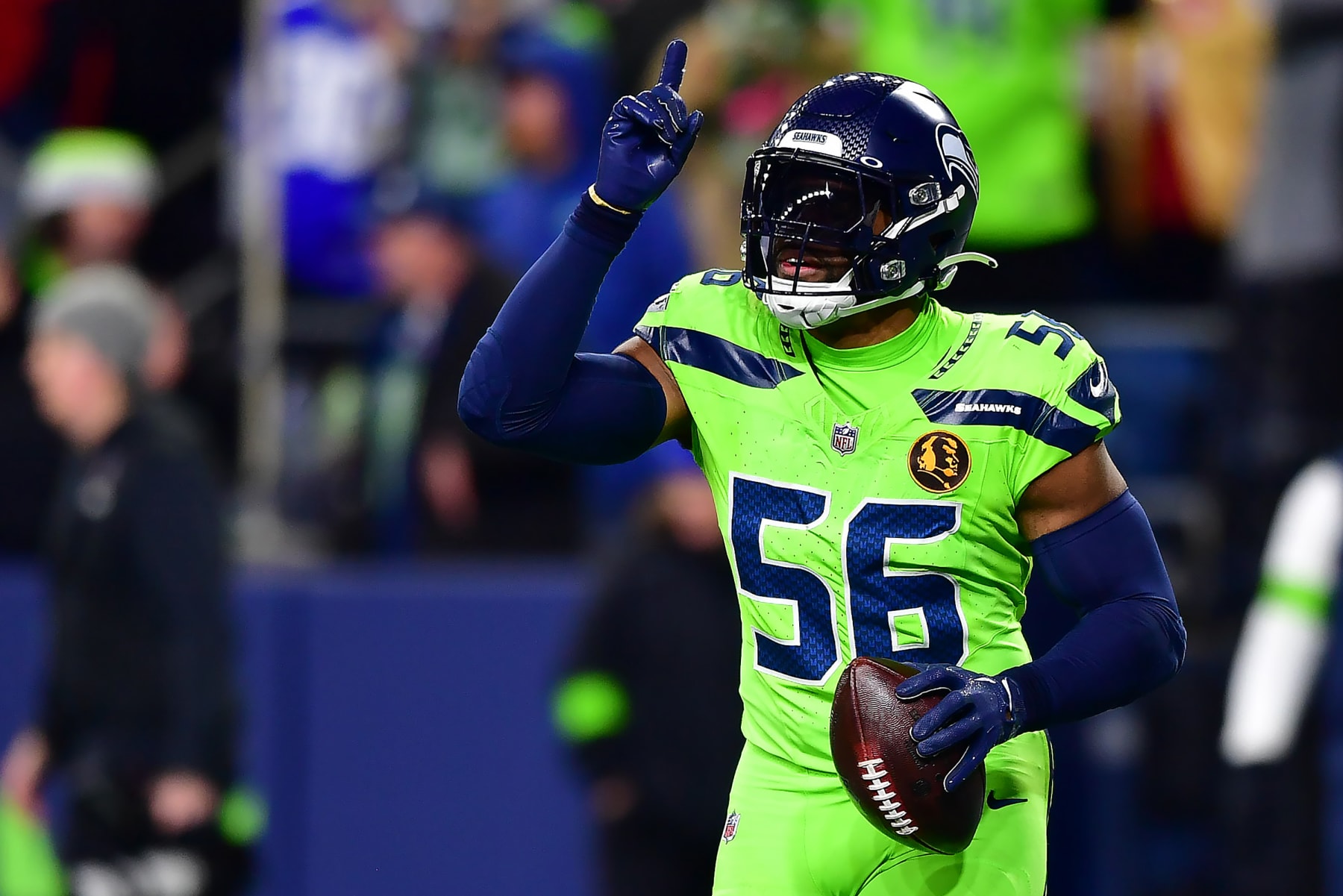 SEATTLE, WASHINGTON - NOVEMBER 23: Jordyn Brooks #56 of the Seattle Seahawks celebrates as he scores a touchdown after intercepting a pass from Brock Purdy #13 of the San Francisco 49ers in the third quarter at Lumen Field on November 23, 2023 in Seattle, Washington. (Photo by Jane Gershovich/Getty Images)