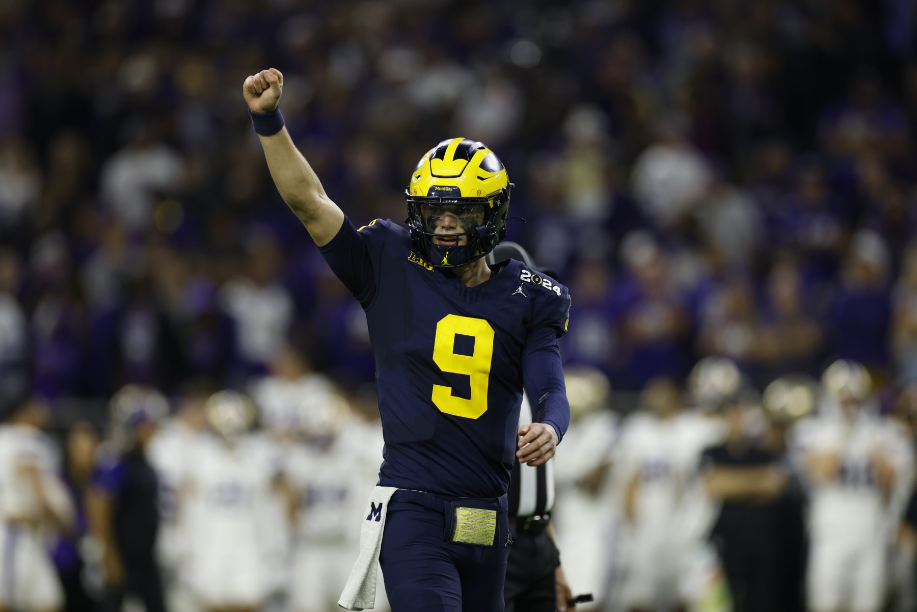 HOUSTON, TX - JANUARY 08: QB J.J. McCarthy (9) of the Michigan Wolverines celebrates after a Michigan touchdown in the fourth quarter during the Michigan Wolverines versus the Washington Huskies CFP National Championship game on January 8, 2024, at NRG Stadium in Houston, TX. (Photo by Joe Robbins/Icon Sportswire via Getty Images)