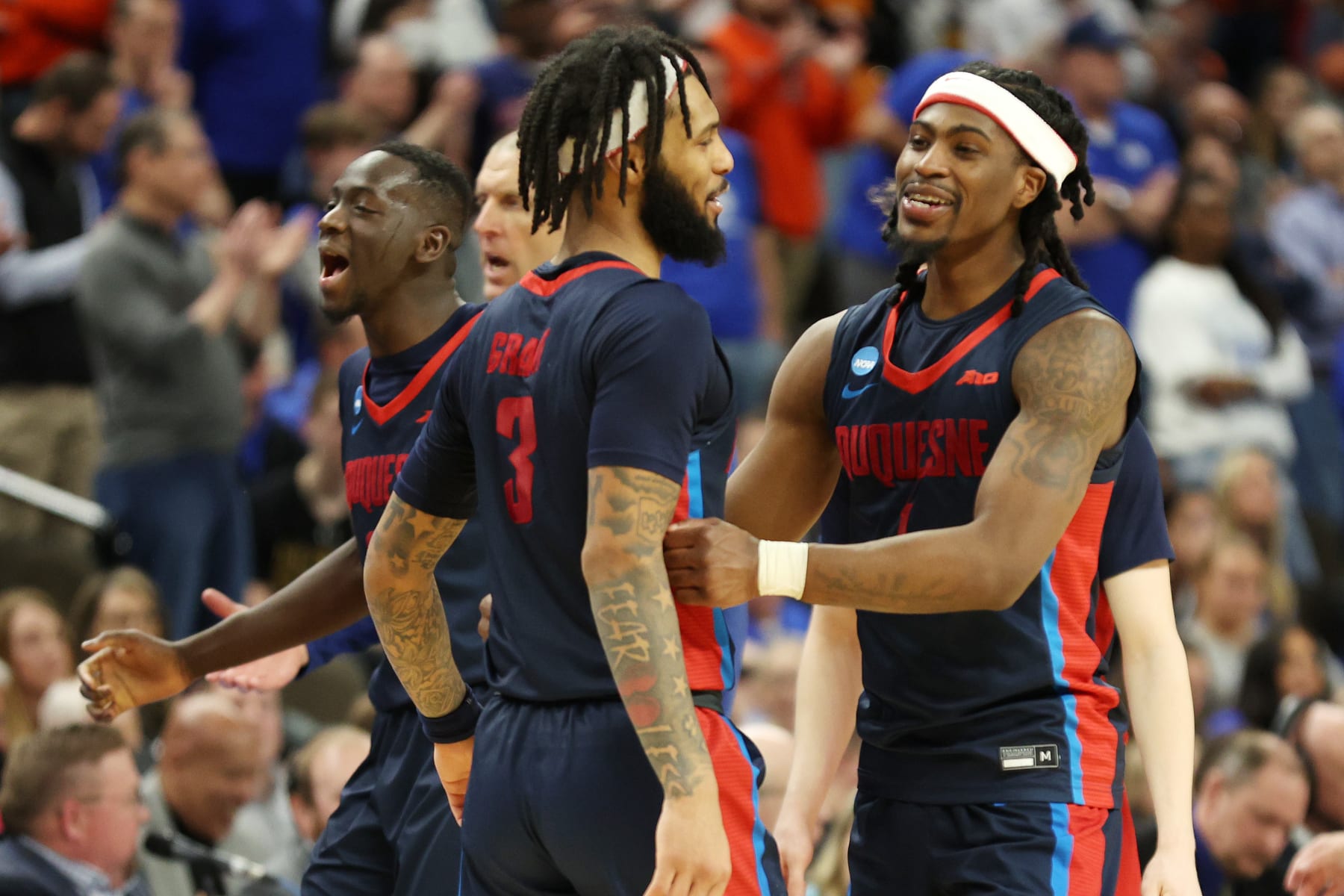 OMAHA, NEBRASKA - MARCH 21: Members of the Duquesne Dukes celebrate after defeating Brigham Young Cougars during the second half in the first round of the NCAA Men's Basketball Tournament at CHI Health Center on March 21, 2024 in Omaha, Nebraska. (Photo by Jamie Squire/Getty Images)