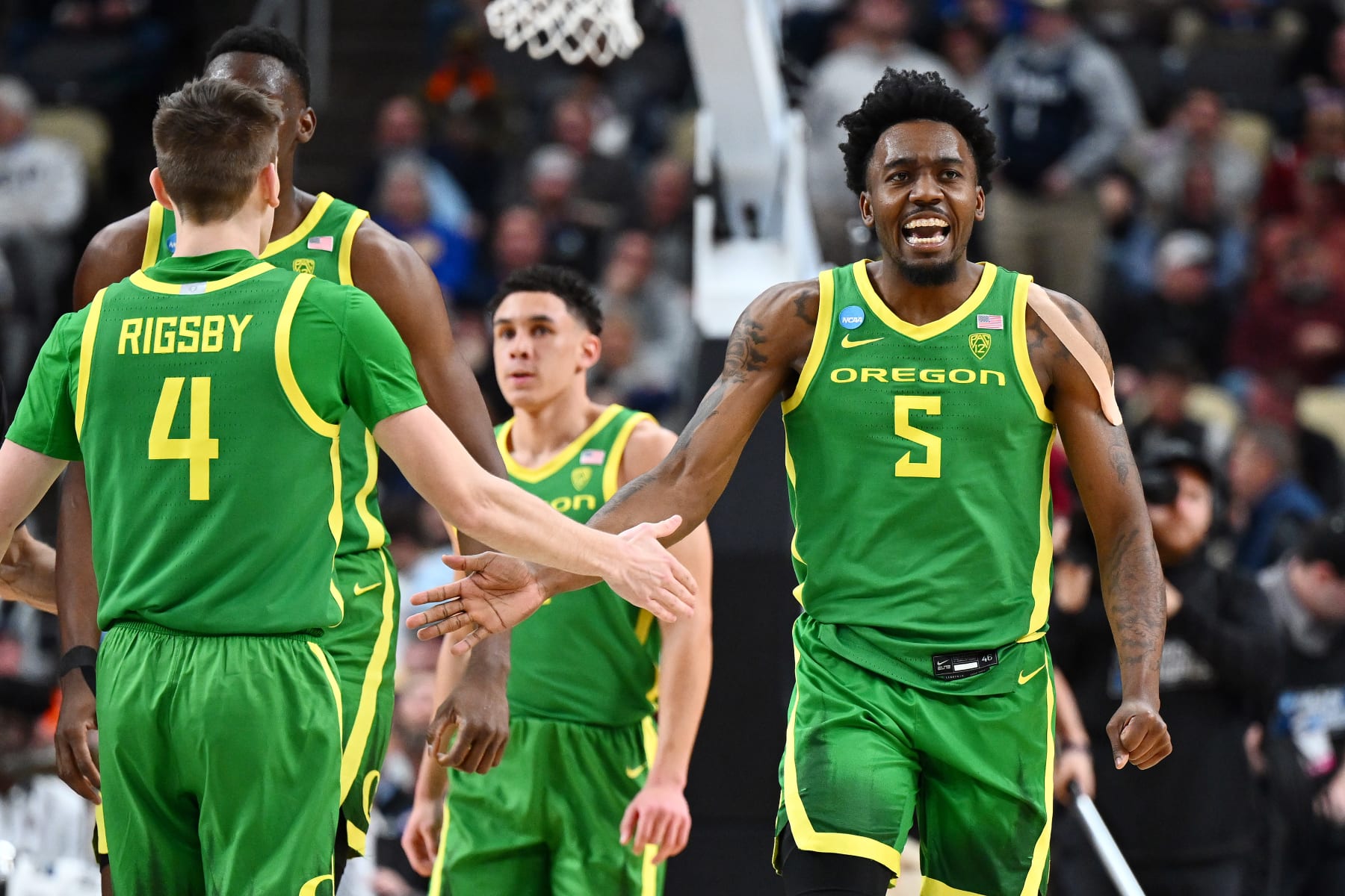 PITTSBURGH, PENNSYLVANIA - MARCH 21: Jermaine Couisnard #5 celebrates with Brennan Rigsby #4 of the Oregon Ducks in the second half against the South Carolina Gamecocks in the first round of the NCAA Men's Basketball Tournament at PPG PAINTS Arena on March 21, 2024 in Pittsburgh, Pennsylvania. (Photo by Joe Sargent/Getty Images)