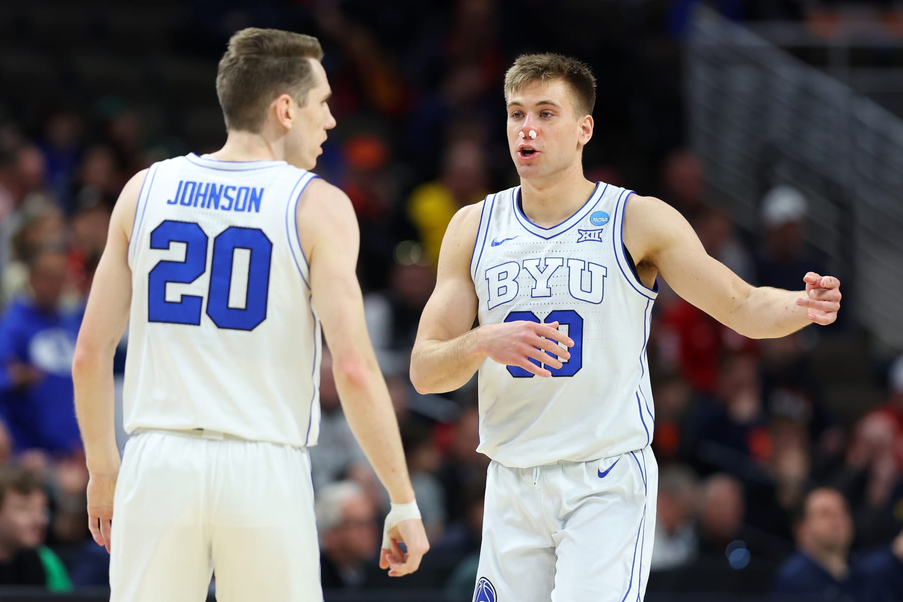 OMAHA, NEBRASKA - MARCH 21: Spencer Johnson #20 and Dallin Hall #30 of the Brigham Young Cougars talk during the game against the Duquesne Dukes in the first round of the NCAA Men's Basketball Tournament at CHI Health Center on March 21, 2024 in Omaha, Nebraska. (Photo by Michael Reaves/Getty Images)