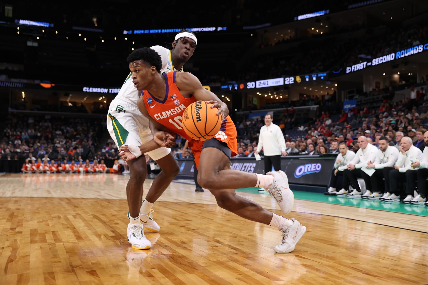 MEMPHIS, TENNESSEE - MARCH 24: RJ Godfrey #10 of the Clemson Tigers drives the ball around Josh Ojianwuna #15 of the Baylor Bears during the second round of the 2024 NCAA Men's Basketball Tournament held at FedExForum on March 24, 2024 in Memphis, Tennessee. (Photo by Joe Murphy/NCAA Photos via Getty Images)
