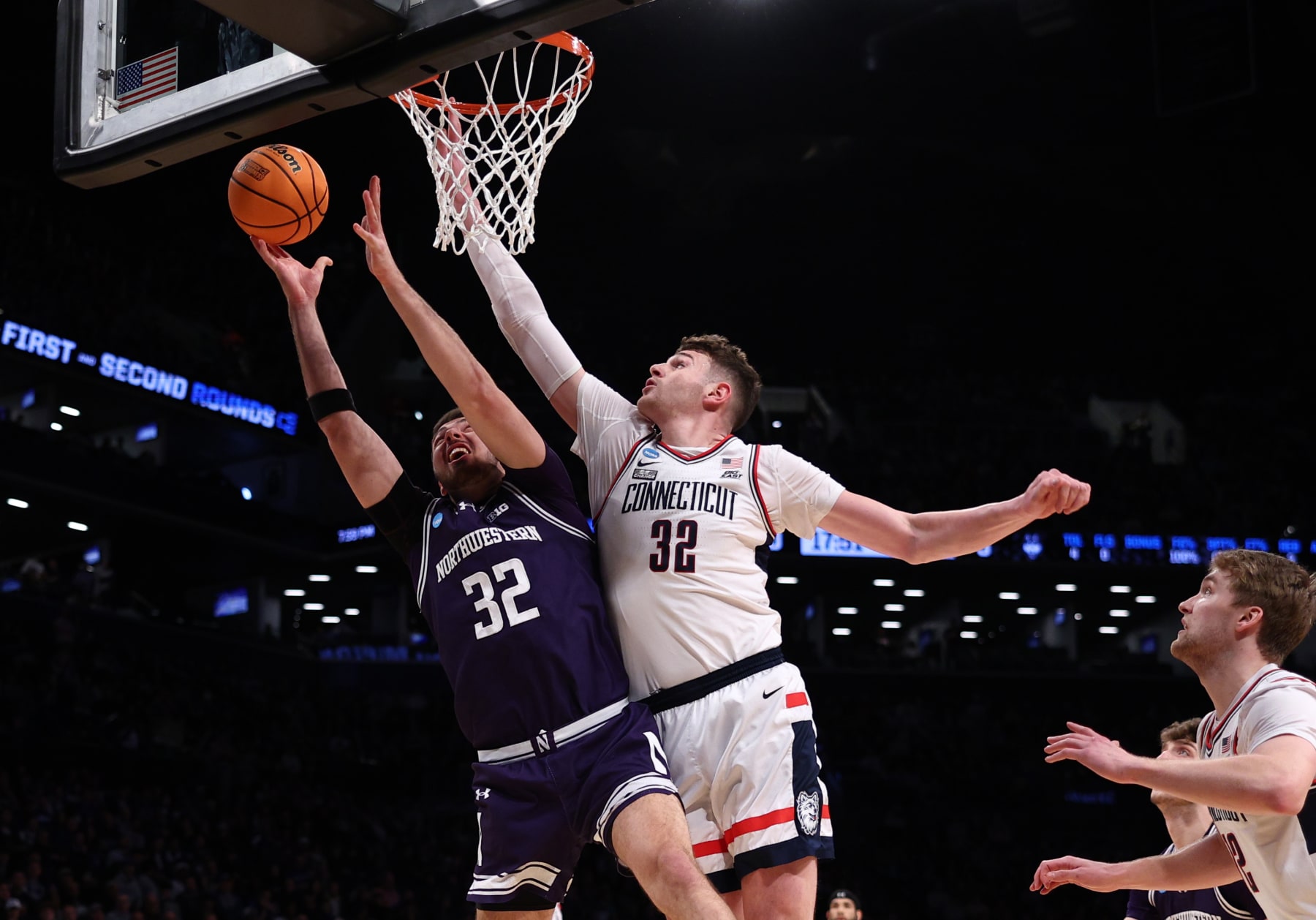 NEW YORK, NEW YORK - MARCH 24: Donovan Clingan #32 of the Connecticut Huskies defends against Blake Preston #32 of the Northwestern Wildcats during the first half in the second round of the NCAA Men's Basketball Tournament at Barclays Center on March 24, 2024 in New York City. (Photo by Elsa/Getty Images)