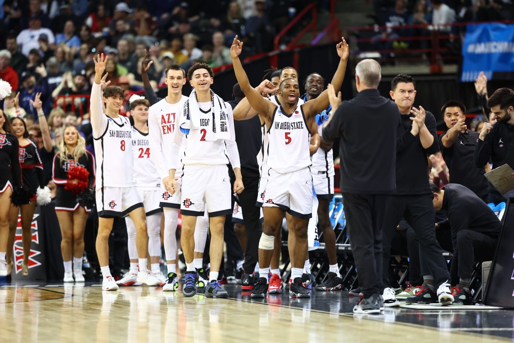 SPOKANE, WASHINGTON - MARCH 24: Lamont Butler #5 and bench players of the San Diego State Aztecs celebrate in the first half against Yale Bulldogs during the second round of the 2024 NCAA Men's Basketball Tournament held at Spokane Veterans Memorial Arena on March 24, 2024 in Spokane, Washington. (Photo by C. Morgan Engel/NCAA Photos via Getty Images)