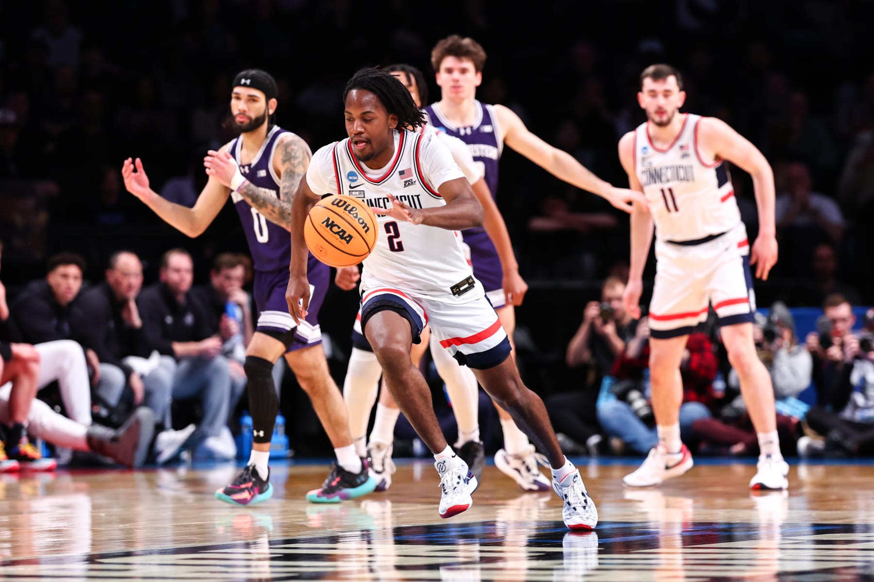 NEW YORK, NEW YORK - MARCH 24: Tristen Newton #2 of the Connecticut Huskies brings the ball up the court during the second half of the game against the Northwestern Wildcats during the second round of the NCAA Men’s Basketball Tournament at Barclays Center on March 24, 2024 in New York City. (Photo by Jamie Schwaberow/NCAA Photos via Getty Images)