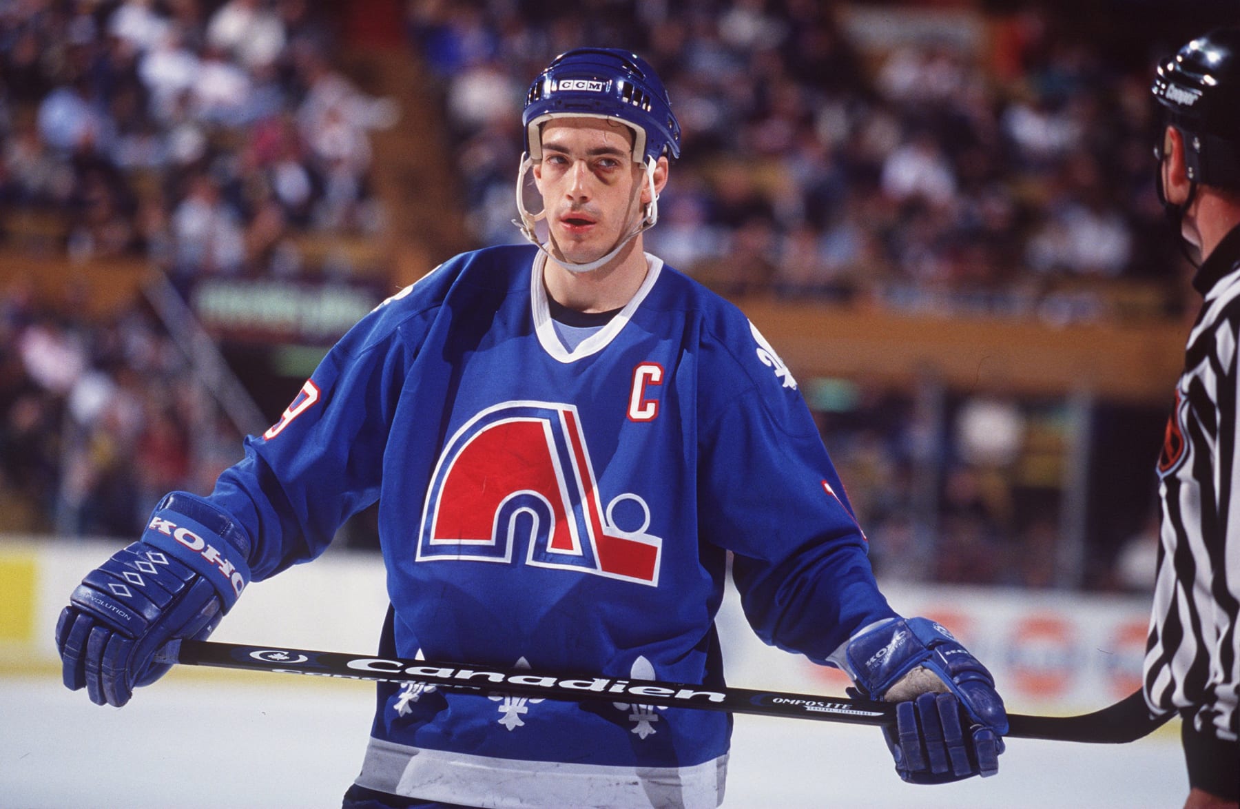 23 MAR 1995:  JOE SAKIC OF THE QUEBEC NORDIQUES SKATES PAST A REFEREE DURING THEIR GAME AGAINST THE BUFFALO SABRES AT THE MEMORIAL AUDITORIUM IN BUFFALO, NEW YORK. Mandatory Credit: Rick Stewart/ALLSPORT