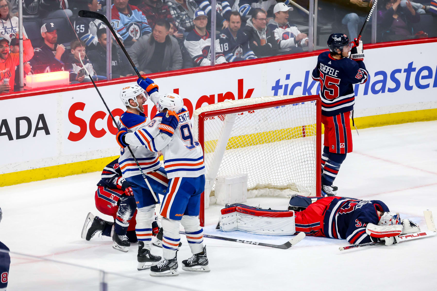 WINNIPEG, CANADA - MARCH 26: Zach Hyman #18 and Ryan Nugent-Hopkins #93 of the Edmonton Oilers celebrate the overtime winning goal against the Winnipeg Jets at the Canada Life Centre on March 26, 2024 in Winnipeg, Manitoba, Canada. The Oilers win the game 4-3. (Photo by Jonathan Kozub/NHLI via Getty Images)