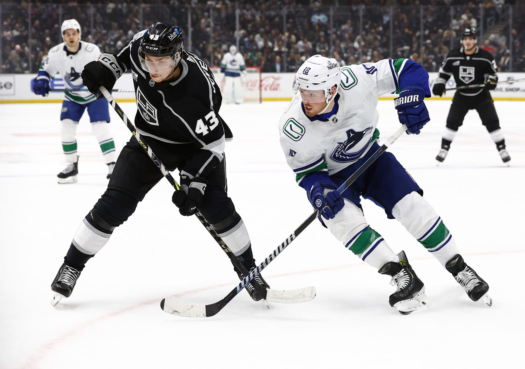 LOS ANGELES, CALIFORNIA - MARCH 05: Jacob Moverare #43 of the Los Angeles Kings skates for the puck against Sam Lafferty #18 of the Vancouver Canucks in the first period at Crypto.com Arena on March 05, 2024 in Los Angeles, California. (Photo by Ronald Martinez/Getty Images)