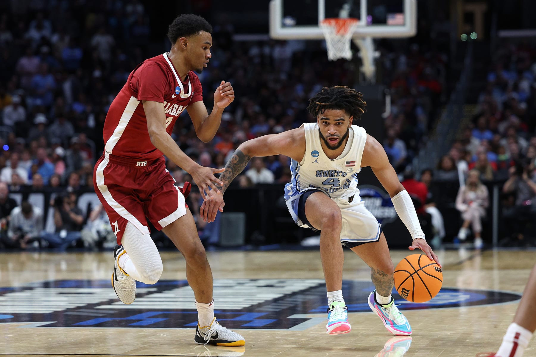 LOS ANGELES, CALIFORNIA - MARCH 28: RJ Davis #4 of the North Carolina Tar Heels drives against Rylan Griffen #3 of the Alabama Crimson Tide during the second half in the Sweet 16 round of the NCAA Men's Basketball Tournament at Crypto.com Arena on March 28, 2024 in Los Angeles, California. (Photo by Harry How/Getty Images)