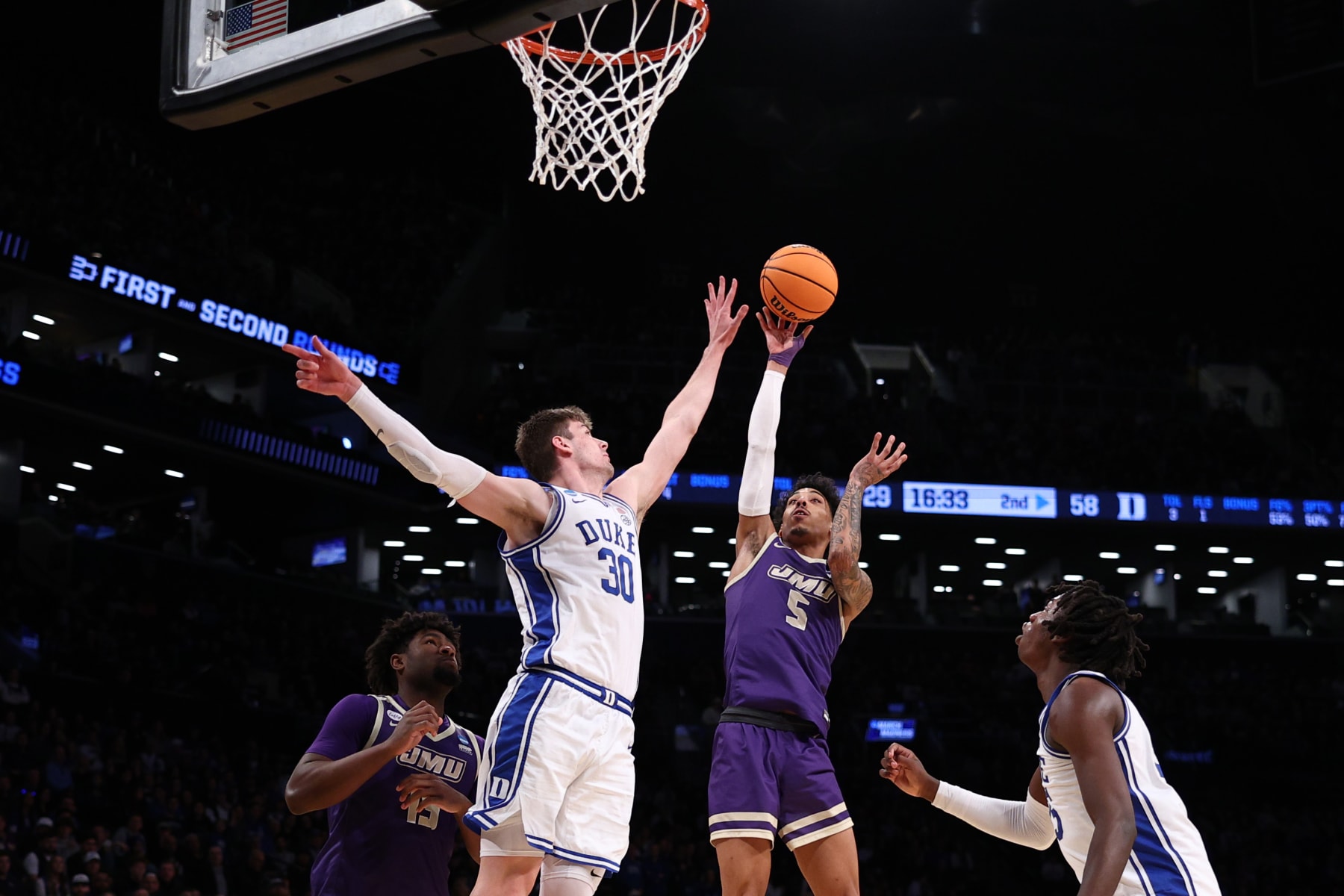 NEW YORK, NEW YORK - MARCH 24: Terrence Edwards Jr. #5 of the James Madison Dukes shoots the ball against Kyle Filipowski #30 of the Duke Blue Devils during the second half in the second round of the NCAA Men's Basketball Tournament at Barclays Center on March 24, 2024 in New York City. (Photo by Elsa/Getty Images)