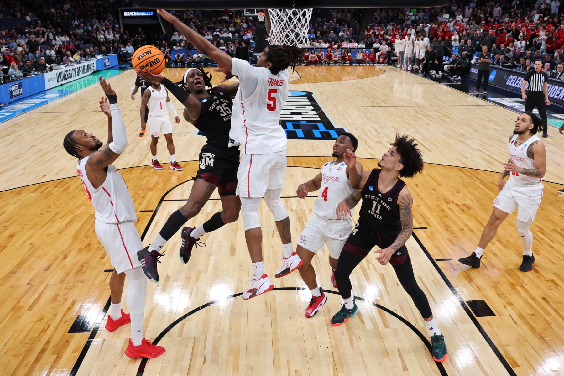 MEMPHIS, TENNESSEE - MARCH 24: Manny Obaseki #35 of the Texas A&M Aggies attempts to shoot the ball between J'Wan Roberts #13 and Ja'Vier Francis #5 of the Houston Cougars during the second half in the second round of the NCAA Men's Basketball Tournament at FedExForum on March 24, 2024 in Memphis, Tennessee. (Photo by Stacy Revere/Getty Images)