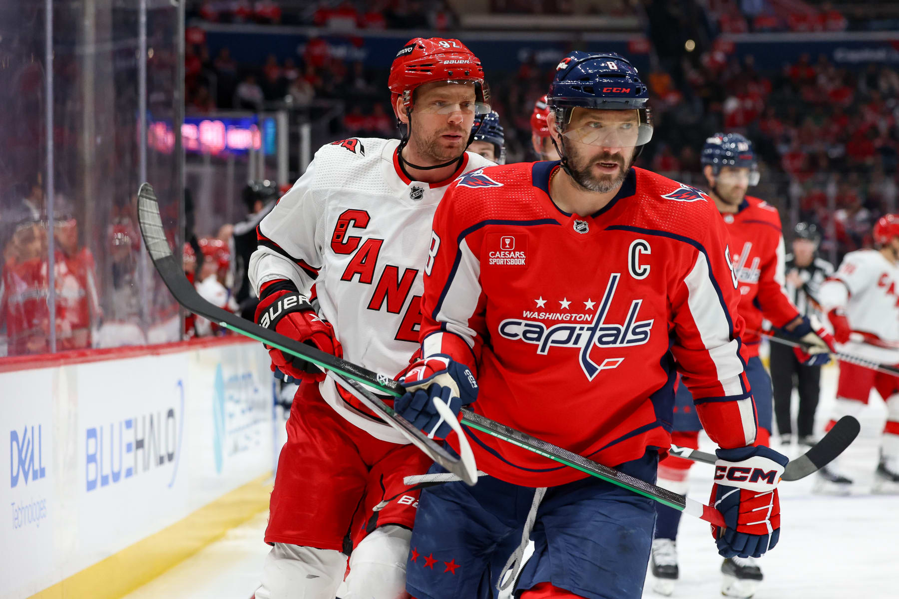 WASHINGTON, DC - MARCH 22: Alex Ovechkin #8 of the Washington Capitals and Evgeny Kuznetsov #92 of the Carolina Hurricanes bump into each other after a stop in play during a game at Capital One Arena on March 22, 2024 in Washington, D.C. (Photo by John McCreary/NHLI via Getty Images)