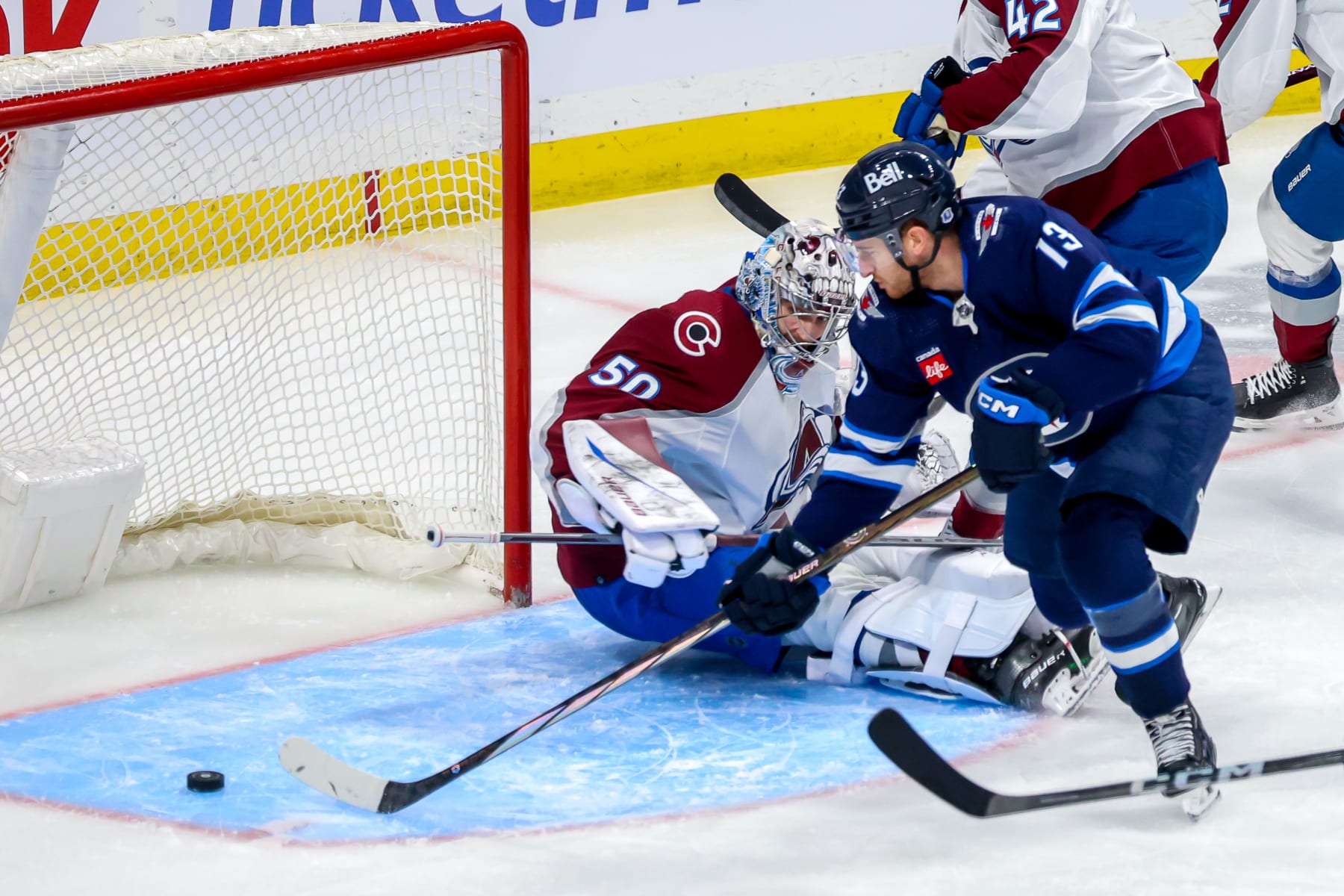 WINNIPEG, CANADA - DECEMBER 16: Gabriel Vilardi #13 of the Winnipeg Jets slides the puck past goaltender Ivan Prosvetov #50 of the Colorado Avalanche for a third period goal at Canada Life Centre on December 16, 2023 in Winnipeg, Manitoba, Canada. (Photo by Jonathan Kozub/NHLI via Getty Images)