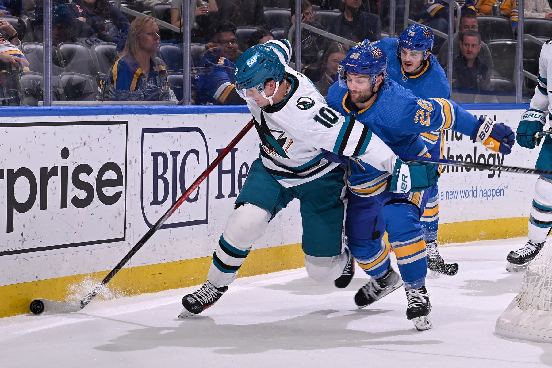 ST. LOUIS, MO - MARCH 30: Nathan Walker #26 of the St. Louis Blues battles Klim Kostin #10 of the San Jose Sharks for the puck on March 30, 2024 at the Enterprise Center in St. Louis, Missouri. (Photo by Joe Puetz/NHLI via Getty Images)