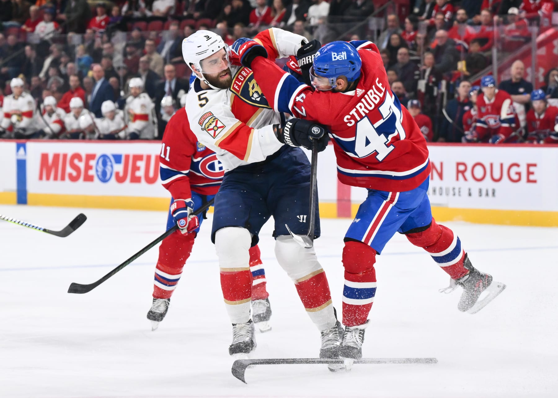 MONTREAL, CANADA - APRIL 02: Jayden Struble #47 of the Montreal Canadiens defends against Aaron Ekblad #5 of the Florida Panthersduring the first period at the Bell Centre on April 2, 2024 in Montreal, Quebec, Canada. (Photo by Minas Panagiotakis/Getty Images)