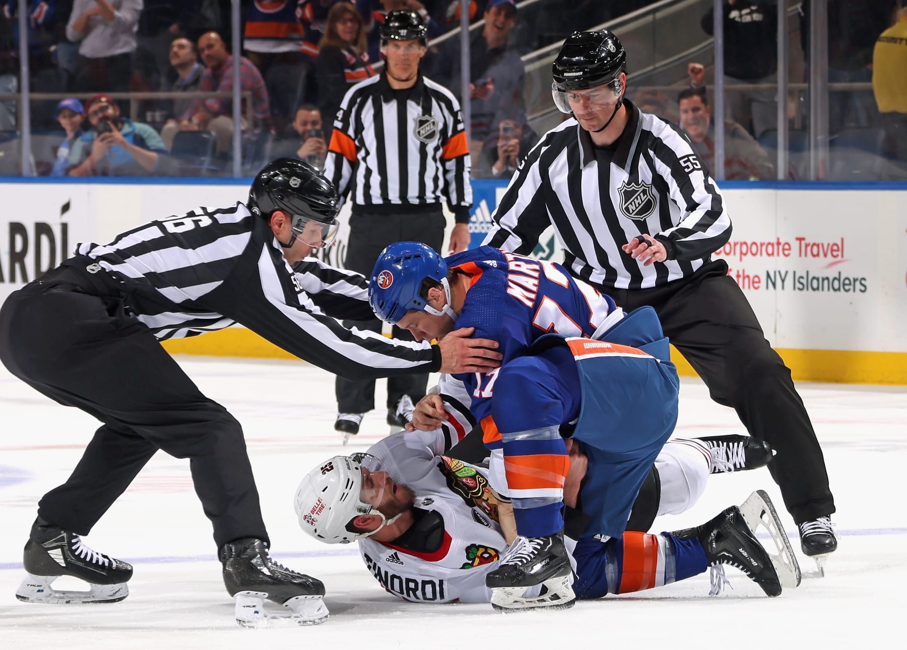 ELMONT, NEW YORK - APRIL 02: Matt Martin #17 of the New York Islanders and Jarred Tinordi #25 of the Chicago Blackhawks fight during the first period at UBS Arena on April 02, 2024 in Elmont, New York. (Photo by Bruce Bennett/Getty Images)