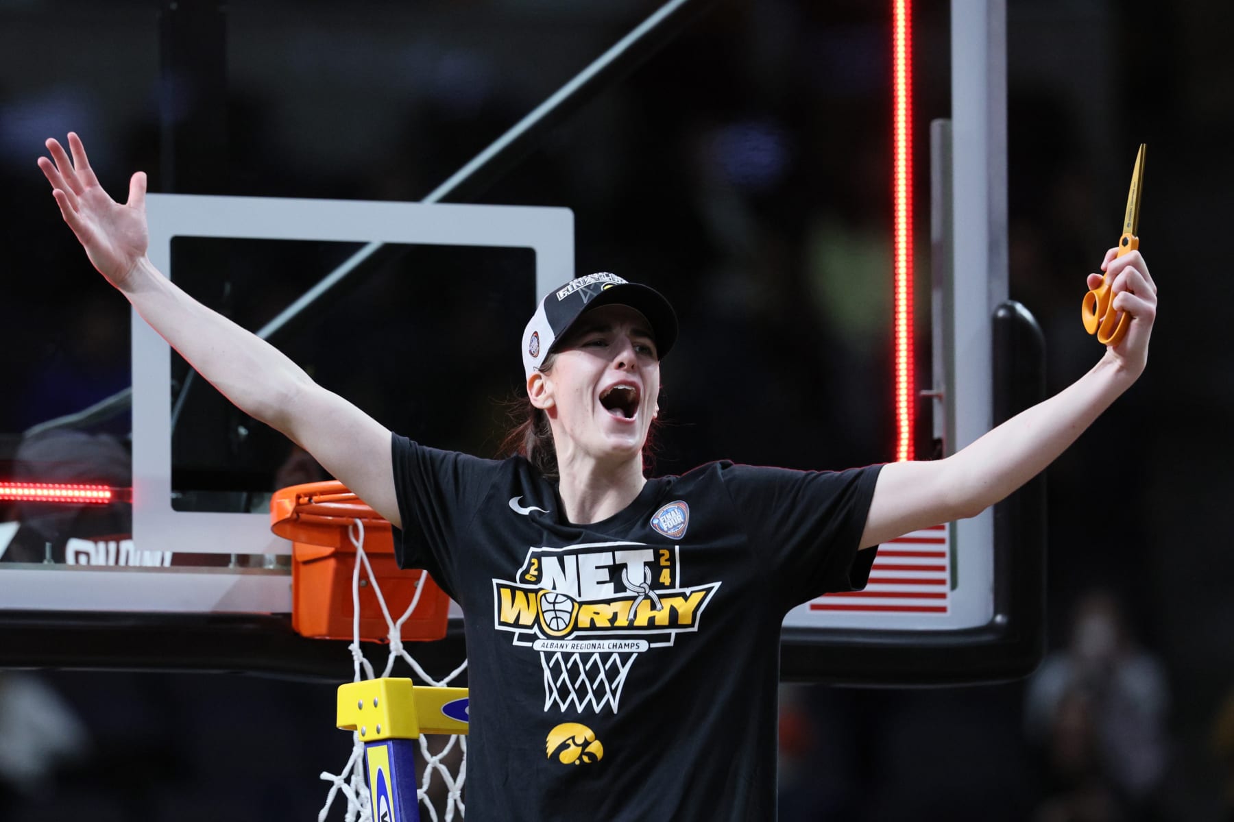 ALBANY, NEW YORK - APRIL 01: Caitlin Clark #22 of the Iowa Hawkeyes cuts down the net after beating the LSU Tigers 94-87 in the Elite 8 round of the NCAA Women's Basketball Tournament at MVP Arena on April 01, 2024 in Albany, New York. (Photo by Andy Lyons/Getty Images)