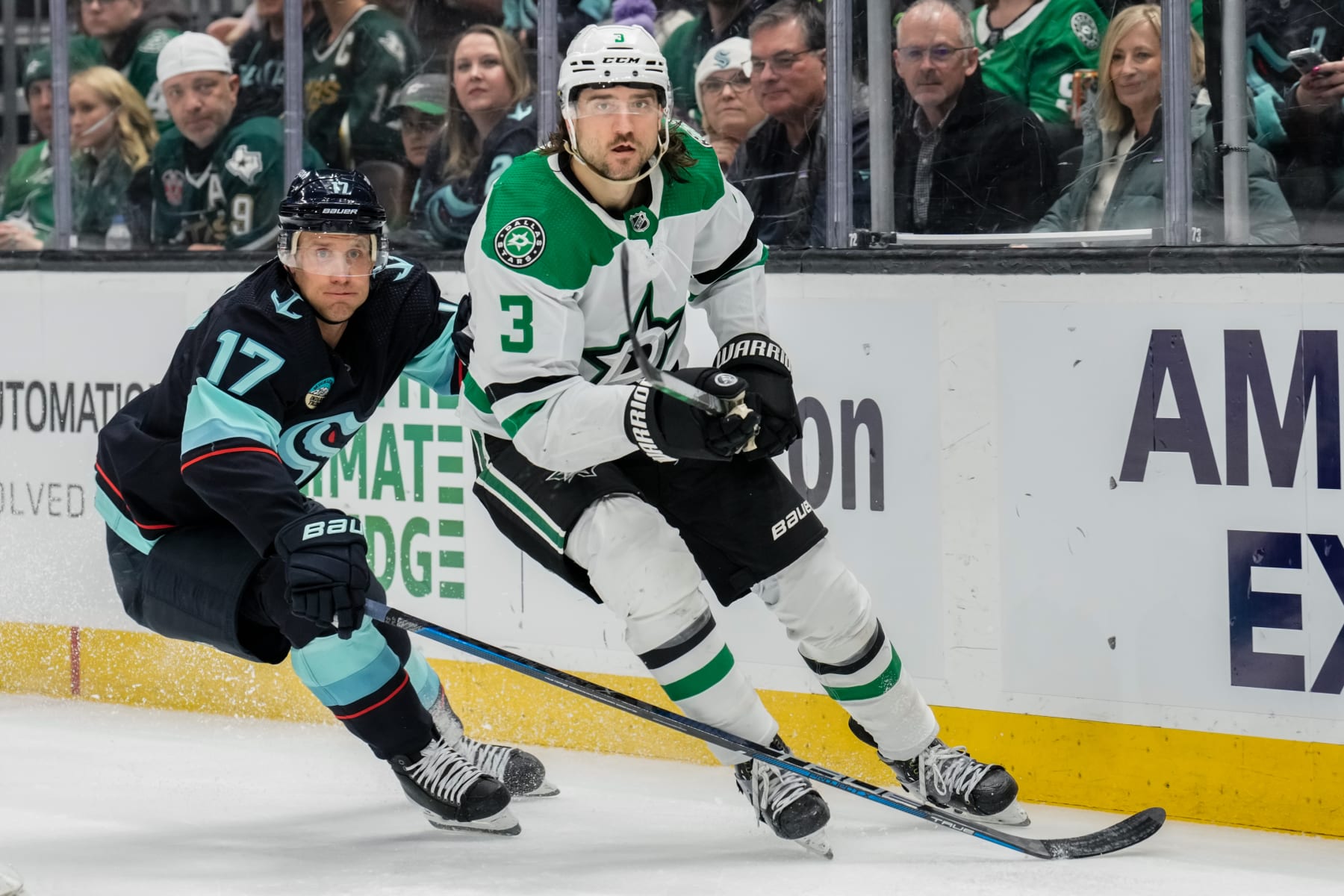 SEATTLE, WASHINGTON - MARCH 30: Jaden Schwartz #17 of the Seattle Kraken and Chris Tanev #3 of the Dallas Stars skate during the second period of a game at Climate Pledge Arena on March 30, 2024 in Seattle, Washington. (Photo by Christopher Mast/NHLI via Getty Images)