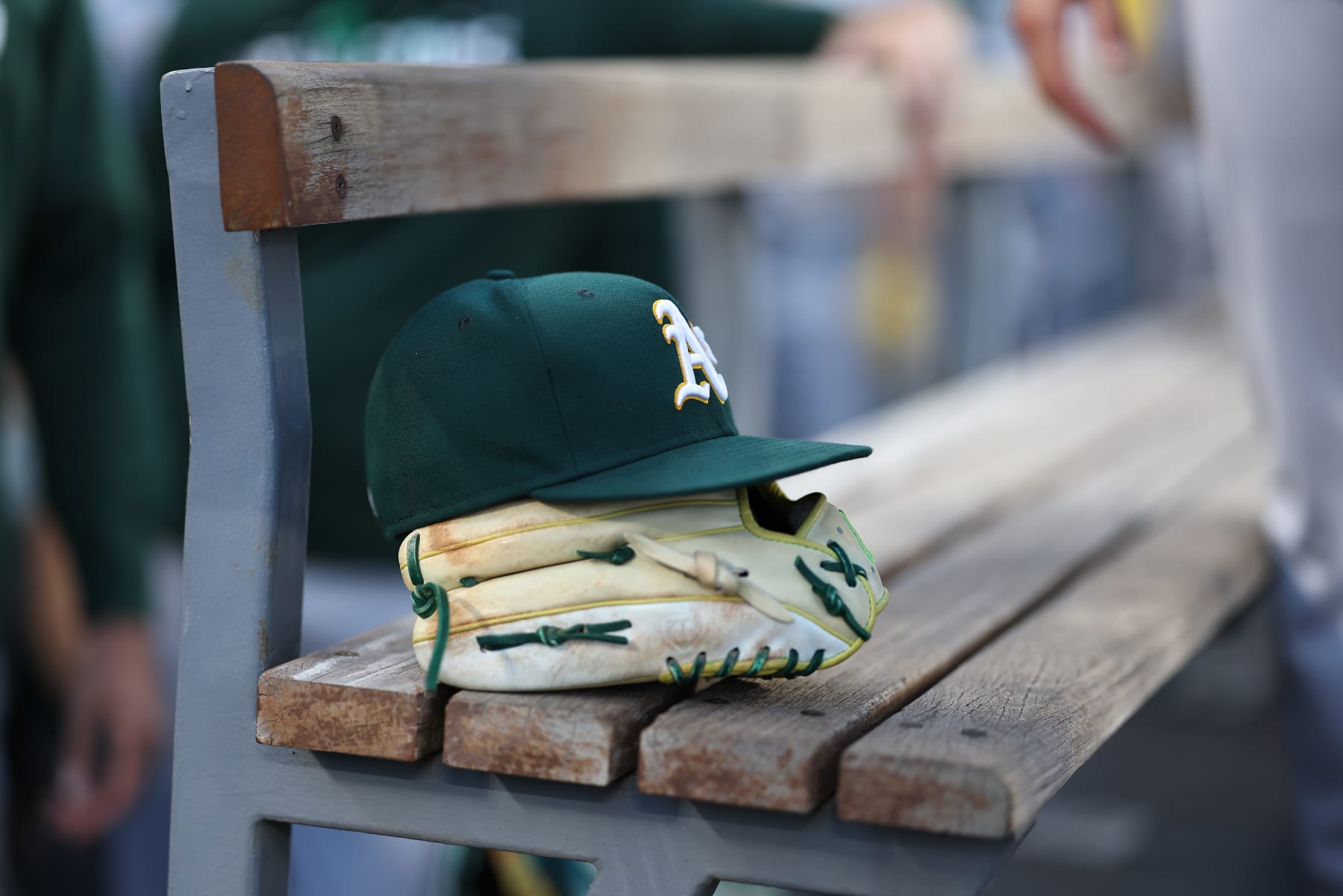 LOS ANGELES, CALIFORNIA - AUGUST 02: A general view of an Oakland Athletics glove and hat in the dugout prior to a game against the Los Angeles Dodgers at Dodger Stadium on August 02, 2023 in Los Angeles, California. (Photo by Michael Owens/Getty Images)