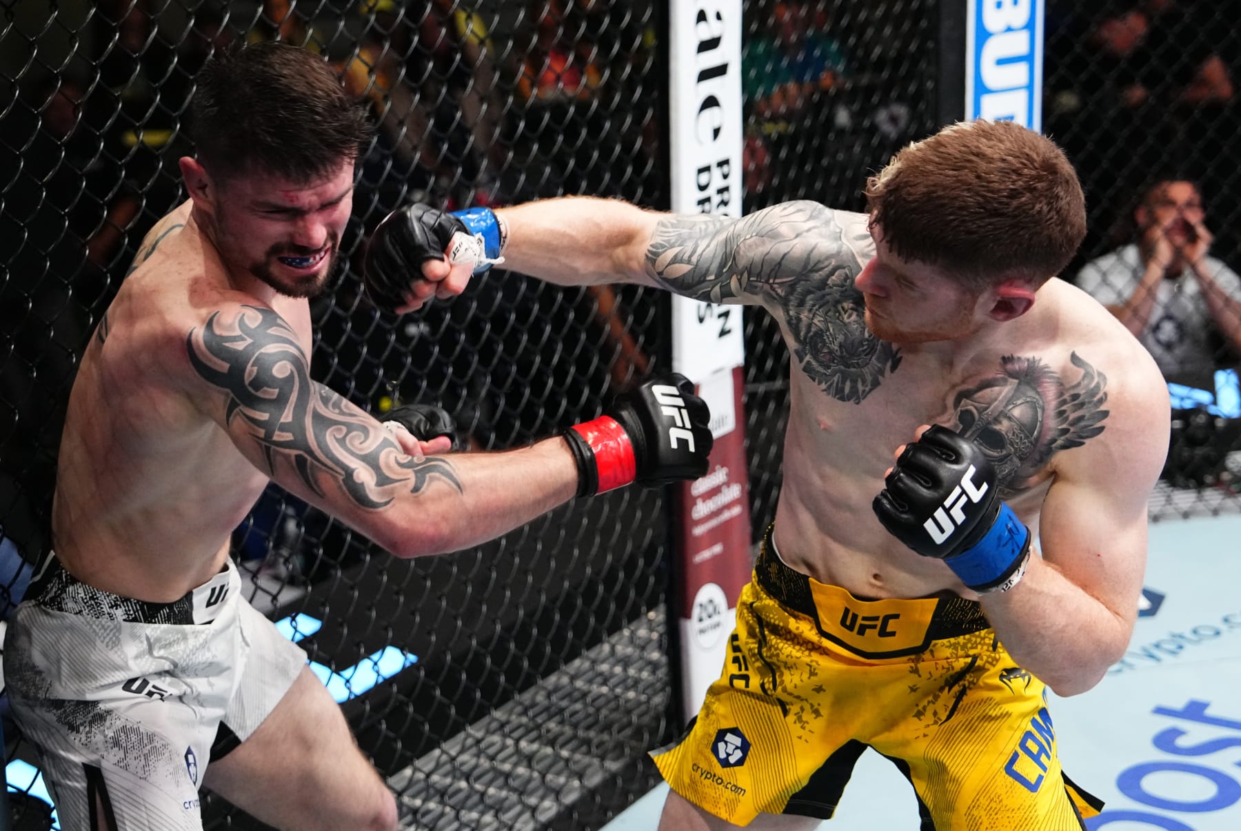 LAS VEGAS, NEVADA - APRIL 06: (R-L) Charlie Campbell punches Trevor Peek in a lightweight fight during the UFC Fight Night event at UFC APEX on April 06, 2024 in Las Vegas, Nevada. (Photo by Jeff Bottari/Zuffa LLC via Getty Images)