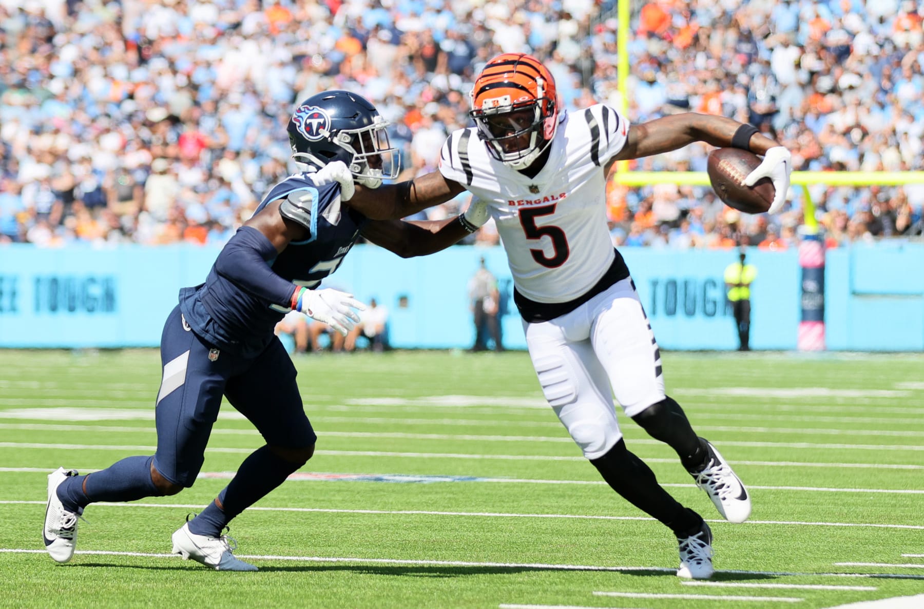 NASHVILLE, TENNESSEE - OCTOBER 01: Tee Higgins #5 of the Cincinnati Bengals runs against Roger McCreary #21 of the Tennessee Titans during the first quarter at Nissan Stadium on October 01, 2023 in Nashville, Tennessee. (Photo by Andy Lyons/Getty Images)