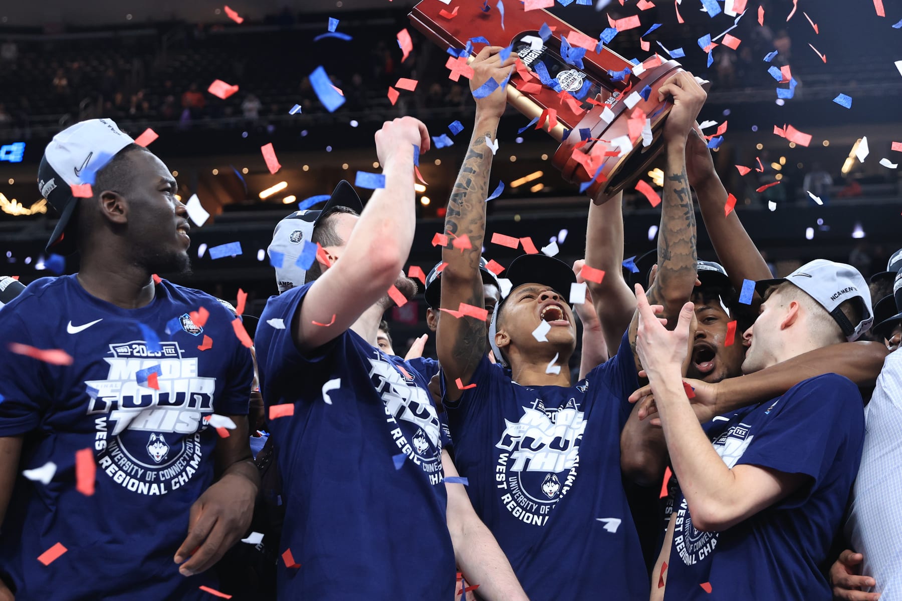 LAS VEGAS, NEVADA - MARCH 25: Jordan Hawkins #24 of the Connecticut Huskies celebrates with teammates and the trophy after defeating the Gonzaga Bulldogs 82-54 in the Elite Eight round of the NCAA Men's Basketball Tournament at T-Mobile Arena on March 25, 2023 in Las Vegas, Nevada. (Photo by Carmen Mandato/Getty Images)