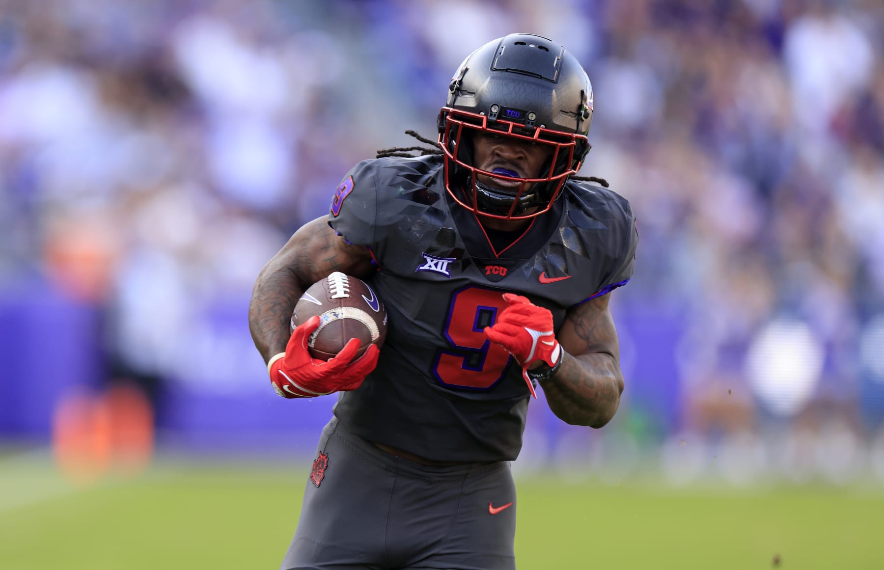 FORT WORTH, TX - NOVEMBER 18: Emani Bailey #9 of the TCU Horned Frogs carries the ball in for a touchdown against the Baylor Bears during the first half at Amon G. Carter Stadium on November 18, 2023 in Fort Worth, Texas. (Photo by Ron Jenkins/Getty Images)