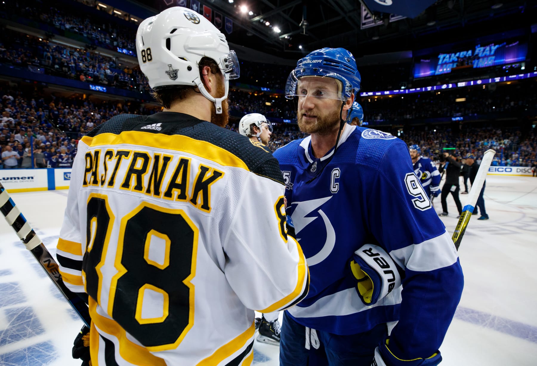 TAMPA, FL - MAY 6: Steven Stamkos #91of the Tampa Bay Lightning celebrates the series win and shakes hands with David Pastrnak #88 of the Boston Bruins during Game Five of the Eastern Conference Second Round during the 2018 NHL Stanley Cup Playoffs at Amalie Arena on May 6, 2018 in Tampa, Florida. (Photo by Scott Audette/NHLI via Getty Images)