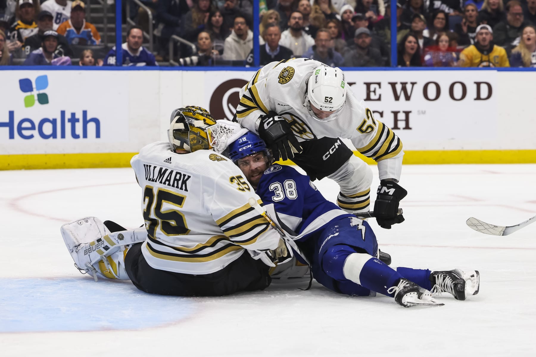 TAMPA, FL - MARCH 27: Brandon Hagel #38 of the Tampa Bay Lightning against is pinned between goalie Linus Ullmark #35 and Andrew Peeke #52 of the Boston Bruins during the third period at Amalie Arena on March 27, 2024 in Tampa, Florida. (Photo by Mark LoMoglio/NHLI via Getty Images)