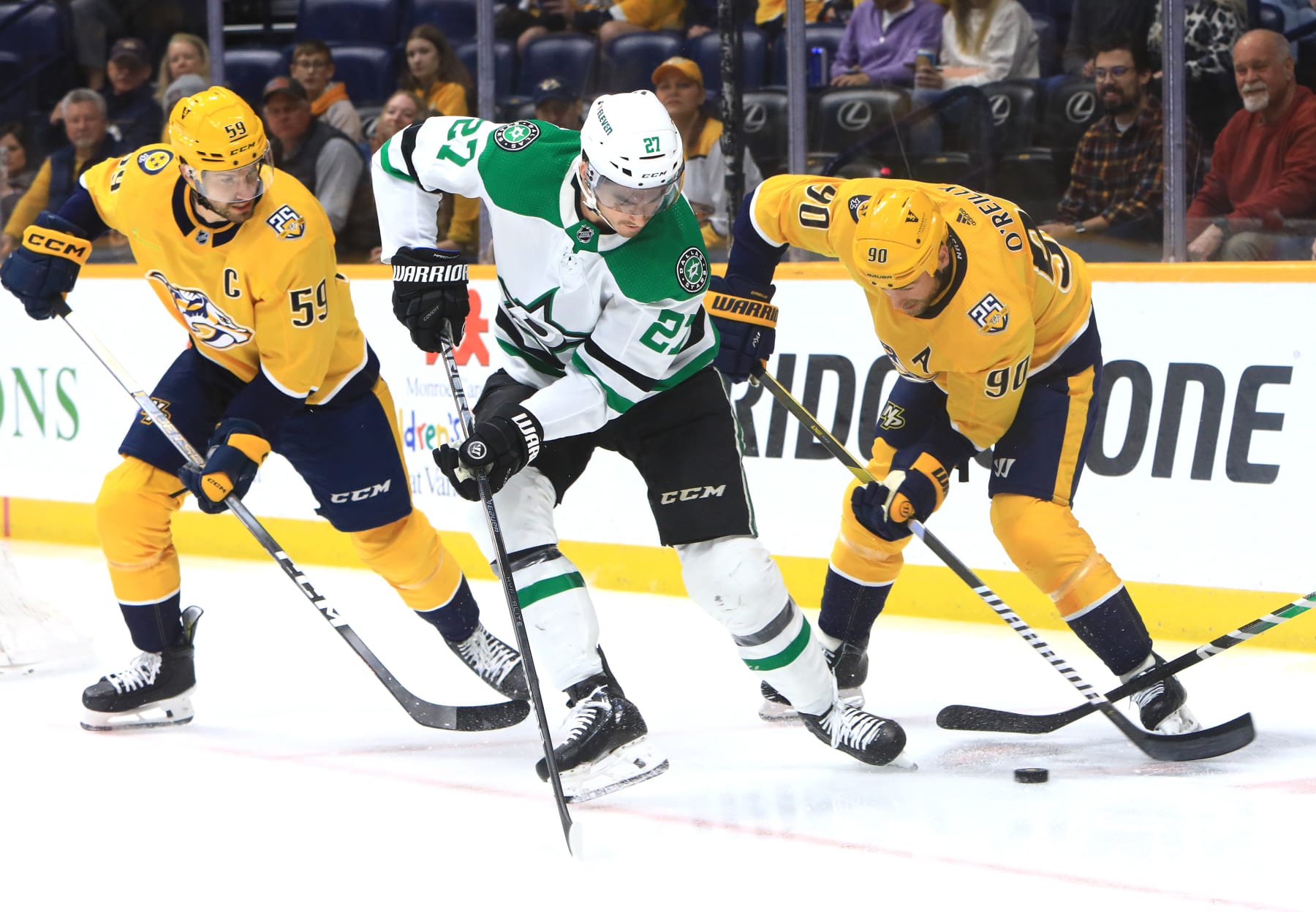 NASHVILLE, TN - FEBRUARY 15: Dallas Stars left wing Mason Marchment (27) challenges Nashville Predators center Ryan O'Reilly (90) for the puck as defenseman Roman Josi (59) looks on during the NHL game between the Nashville Predators and Dallas Stars, held on February 15, 2024, at Bridgestone Arena in Nashville, Tennessee. (Photo by Danny Murphy/Icon Sportswire via Getty Images)