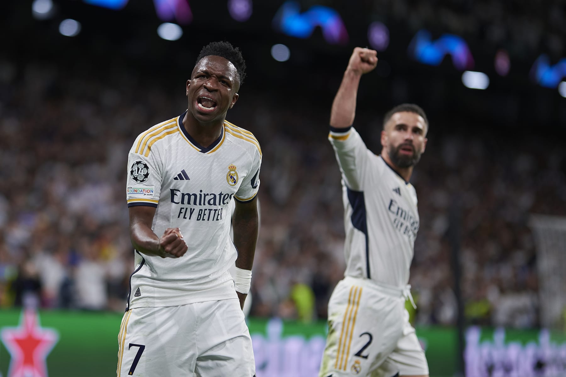MADRID, SPAIN - APRIL 9: Vinicius Júnior and Dani Caravajal of Real Madrid CF celebrates a goal during the Quarter-final First Leg - UEFA Champions League  match between Real Madrid CF and Manchester City at Estadio Santiago Bernabeu on April 9, 2024 in Madrid, Spain. (Photo by Pablo Morano/BSR Agency/Getty Images)