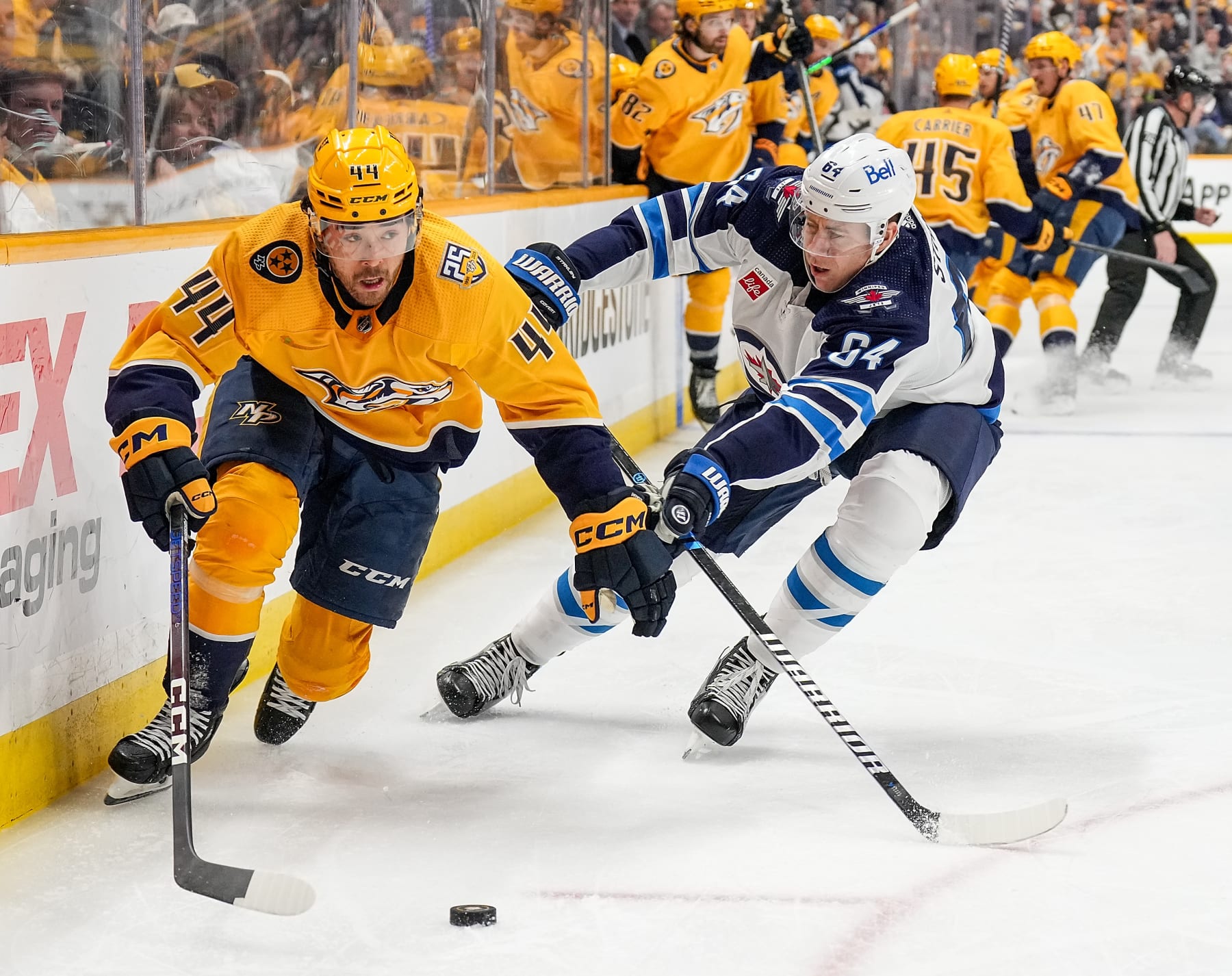 NASHVILLE, TENNESSEE - APRIL 9: Kiefer Sherwood #44 of the Nashville Predators skates against Logan Stanley #64 of the Winnipeg Jets during an NHL game at Bridgestone Arena on April 9, 2024 in Nashville, Tennessee. (Photo by John Russell/NHLI via Getty Images)