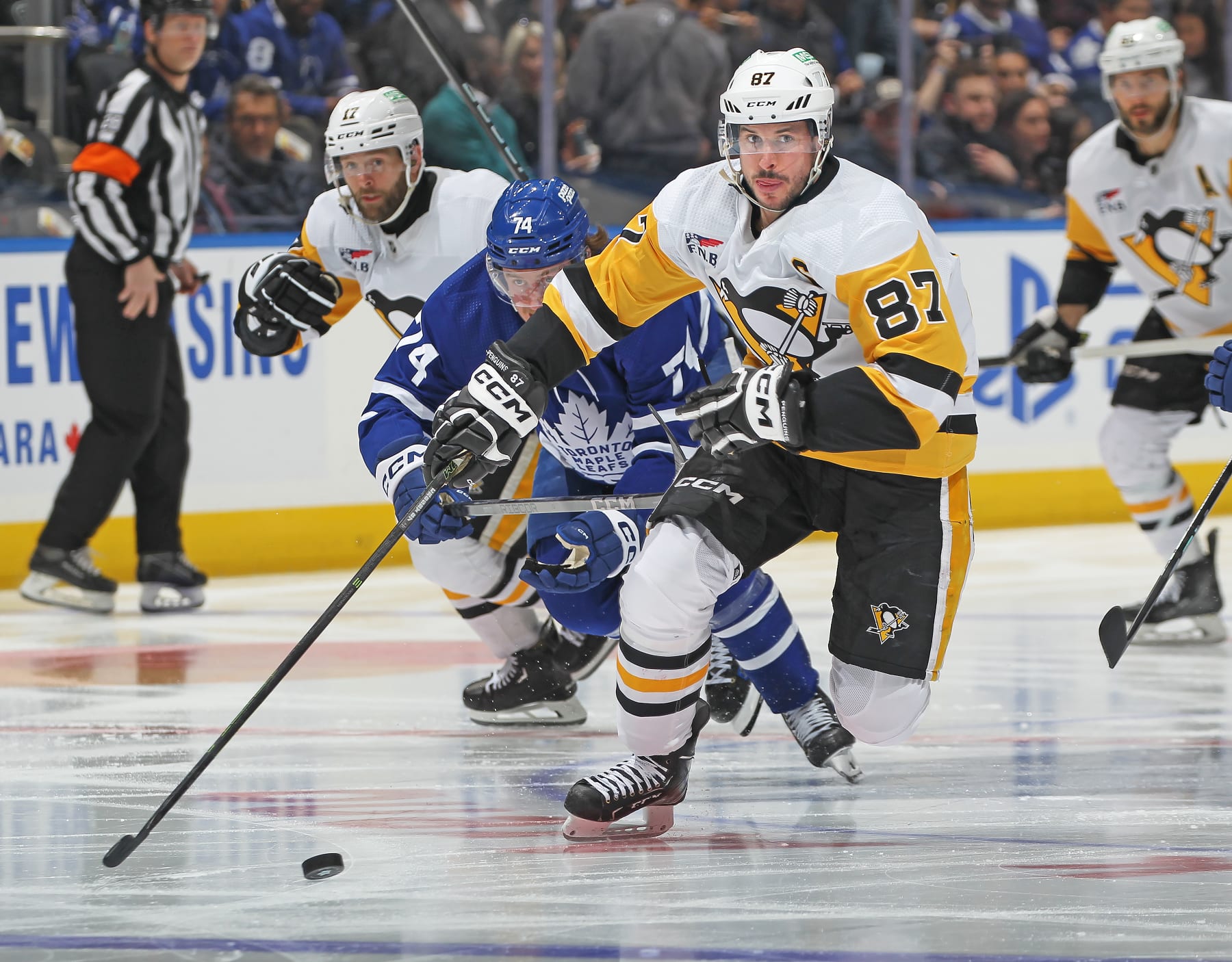 TORONTO, CANADA - APRIL 8: Sidney Crosby #87 of the Pittsburgh Penguins skates the puck against the Toronto Maple Leafs during the third period at Scotiabank Arena on April 8, 2024 in Toronto, Ontario, Canada. The Maple Leafs defeated the Penguins 3-2 in overtime. (Photo by Claus Andersen/Getty Images)