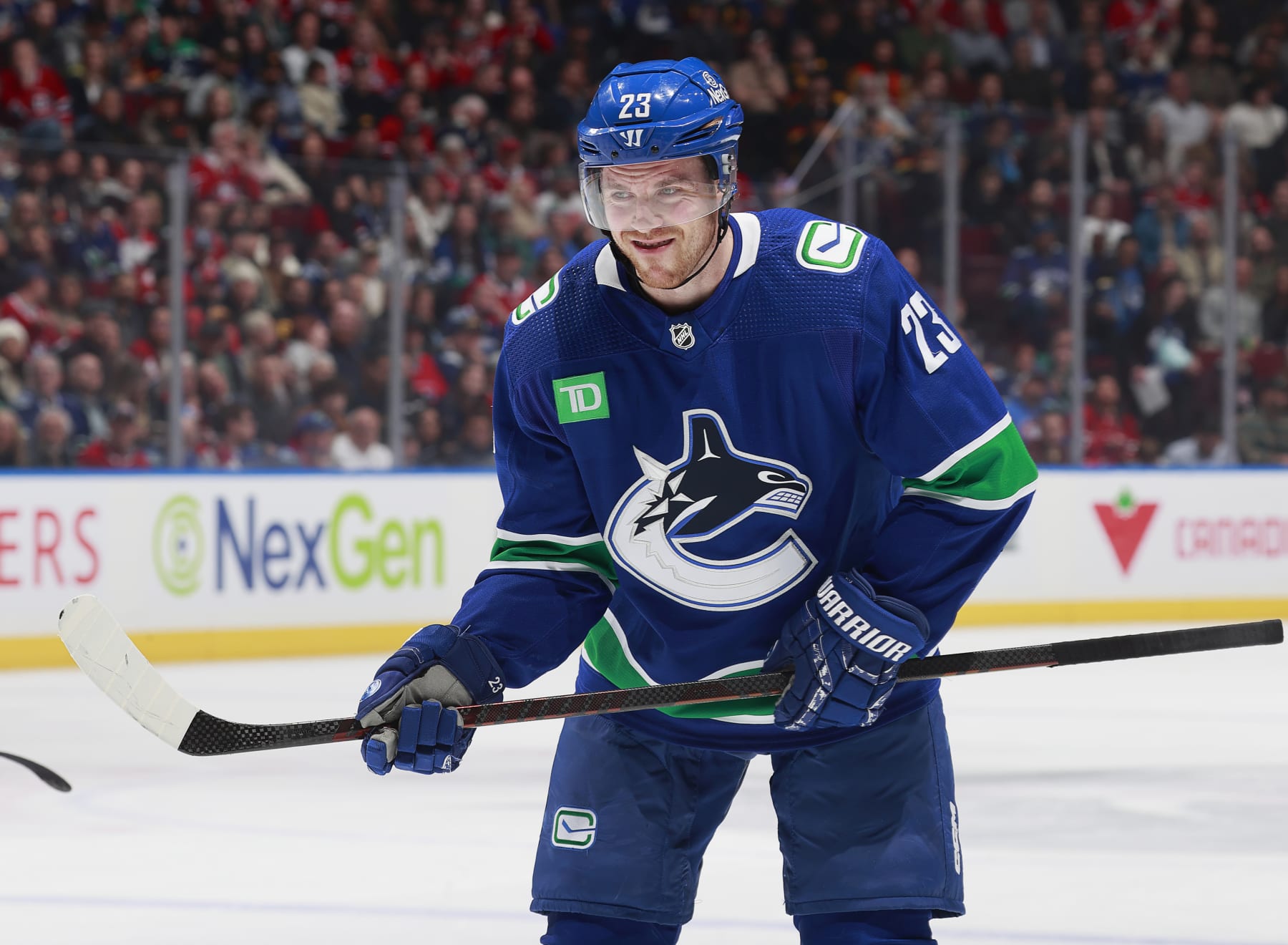 VANCOUVER, CANADA - MARCH 21: Elias Lindholm #23 of the Vancouver Canucks lines up for a face off during their NHL game against the Montréal Canadiens at Rogers Arena on March 21, 2024 in Vancouver, British Columbia, Canada. (Photo by Jeff Vinnick/NHLI via Getty Images)