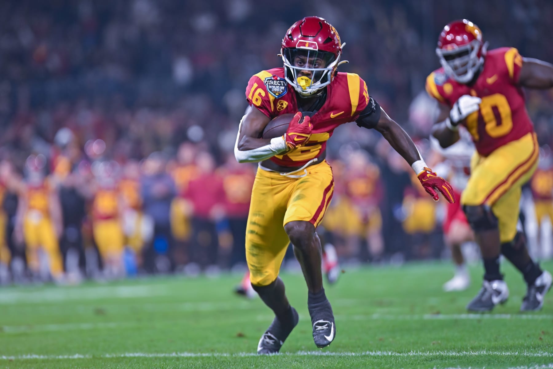 SAN DIEGO, CA - DECEMBER 27:  USC Trojans wide receiver Tahj Washington (16) runs with the ball after a catch during the DIRECTV Holiday Bowl football game between the Louisville Cardinals and the USC Trojans on December 27th, 2023, at Petco Park in San Diego, CA.  (Photo by Justin Fine/Icon Sportswire via Getty Images)