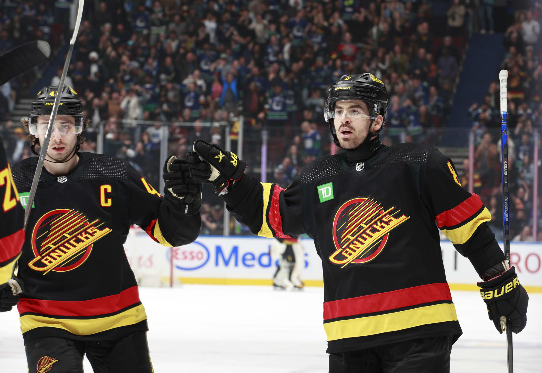 VANCOUVER, CANADA - APRIL 10: Quinn Hughes #43 and Conor Garland #8 of the Vancouver Canucks celebrate a goal during their NHL game against the Arizona Coyotes at Rogers Arena on April 10, 2024 in Vancouver, British Columbia, Canada. (Photo by Jeff Vinnick/NHLI via Getty Images)