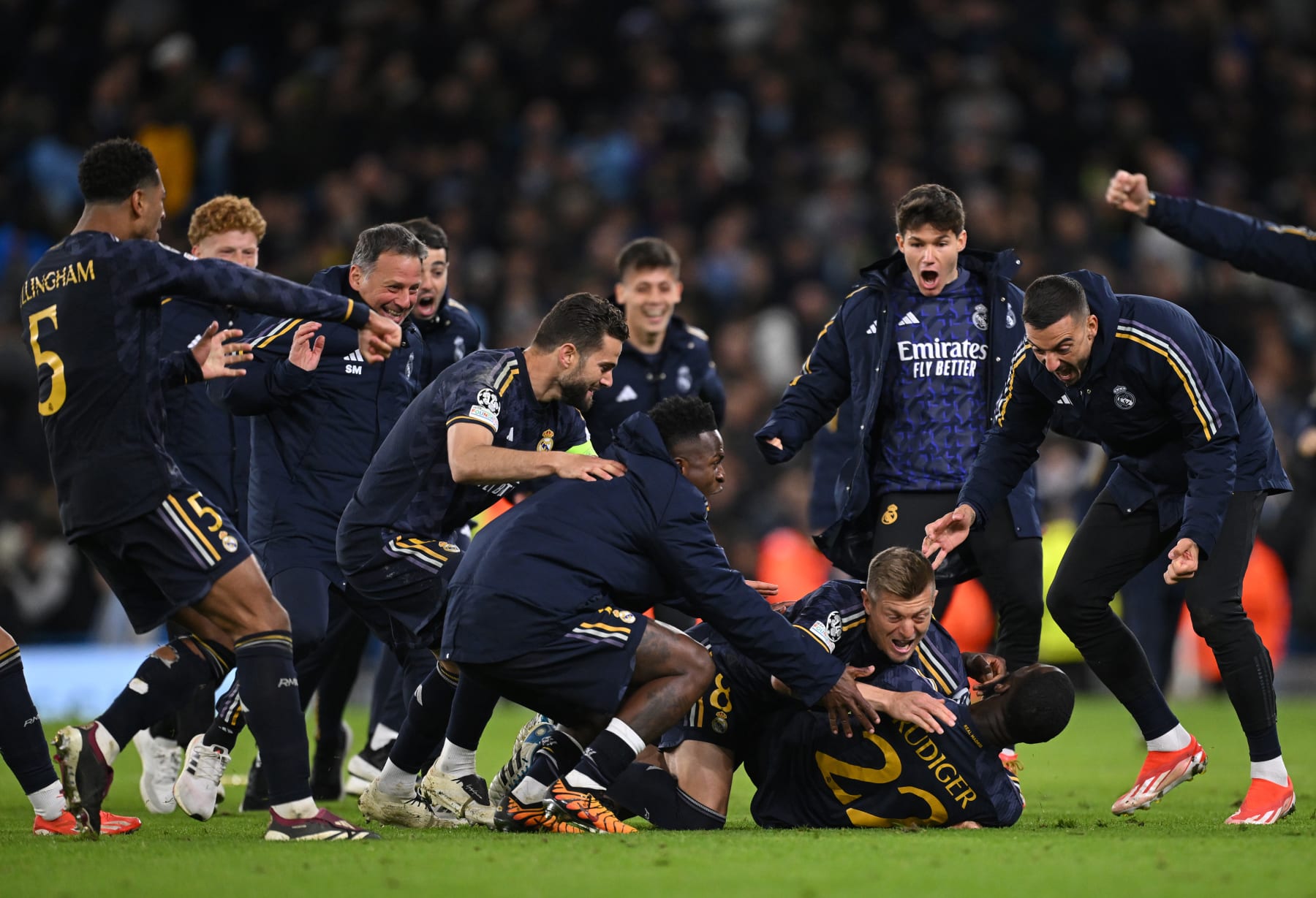 MANCHESTER, ENGLAND - APRIL 17: Antonio Ruediger of Real Madrid celebrates with teammates after scoring the sides winning penalty in the penalty shoot out during the UEFA Champions League quarter-final second leg match between Manchester City and Real Madrid CF at Etihad Stadium on April 17, 2024 in Manchester, England. (Photo by Stu Forster/Getty Images)