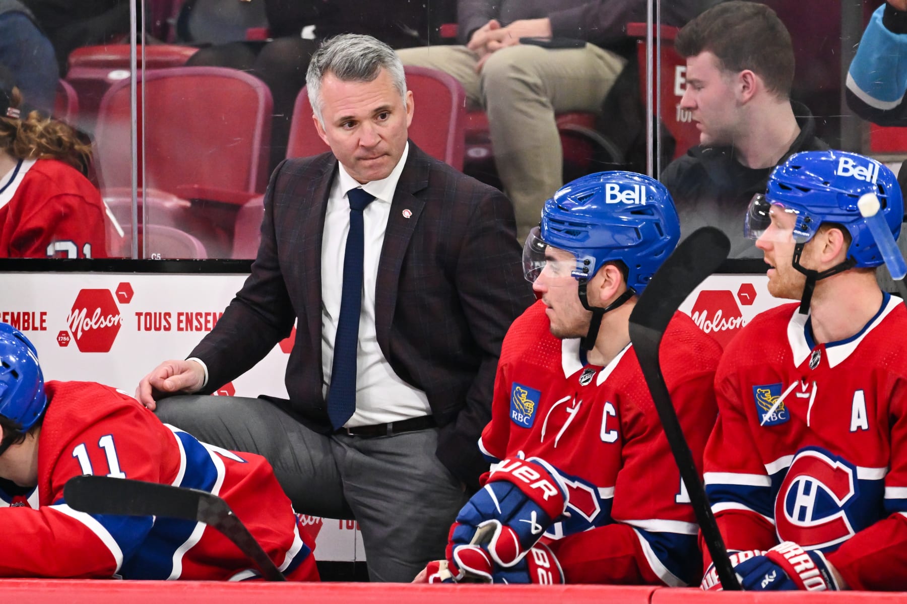 MONTREAL, CANADA - MARCH 30: Head coach of the Montreal Canadiens Martin St-Louis, looks at Nick Suzuki #14 from the bench during the third period against the Carolina Hurricanes at the Bell Centre on March 30, 2024 in Montreal, Quebec, Canada. The Carolina Hurricanes defeated the Montreal Canadiens 3-0. (Photo by Minas Panagiotakis/Getty Images)