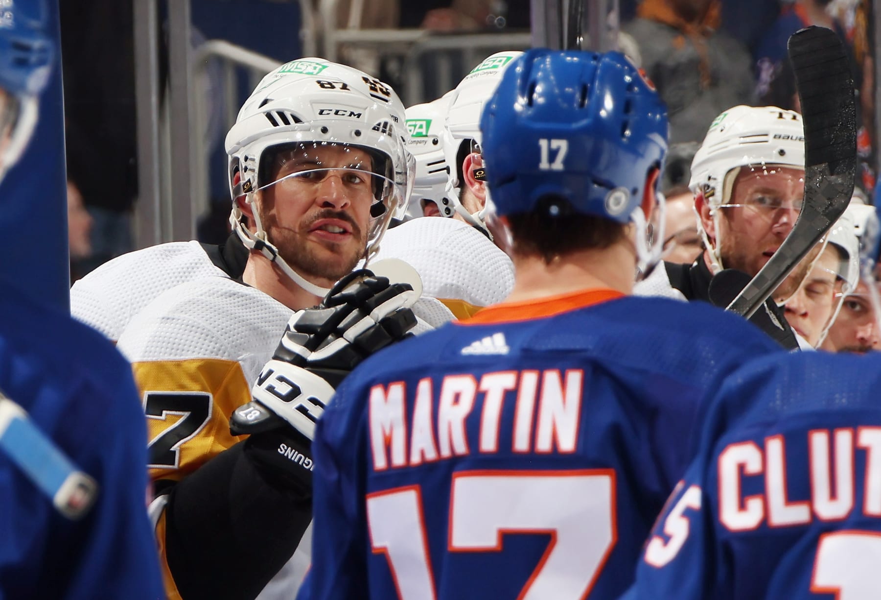 ELMONT, NEW YORK - APRIL 17: Sidney Crosby #87 of the Pittsburgh Penguins talks to Matt Martin #17 of the New York Islanders during the first period at UBS Arena on April 17, 2024 in Elmont, New York. (Photo by Bruce Bennett/Getty Images)