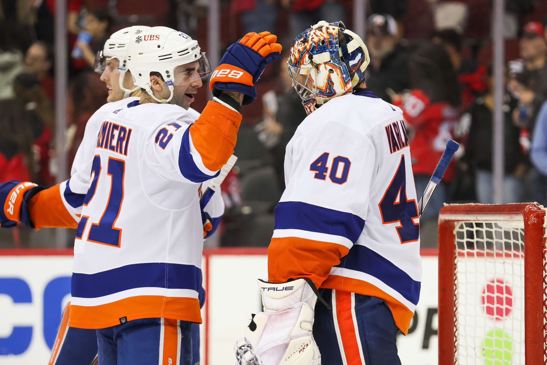 NEWARK, NJ - APRIL 15: New York Islanders center Kyle Palmieri (21) celebrates with New York Islanders goaltender Semyon Varlamov (40) after defeating the New Jersey Devils during a game between the New York Islanders and New Jersey Devils on April 15, 2024 at Prudential Center in the Newark, New Jersey. (Photo by Andrew Mordzynski/Icon Sportswire via Getty Images)
