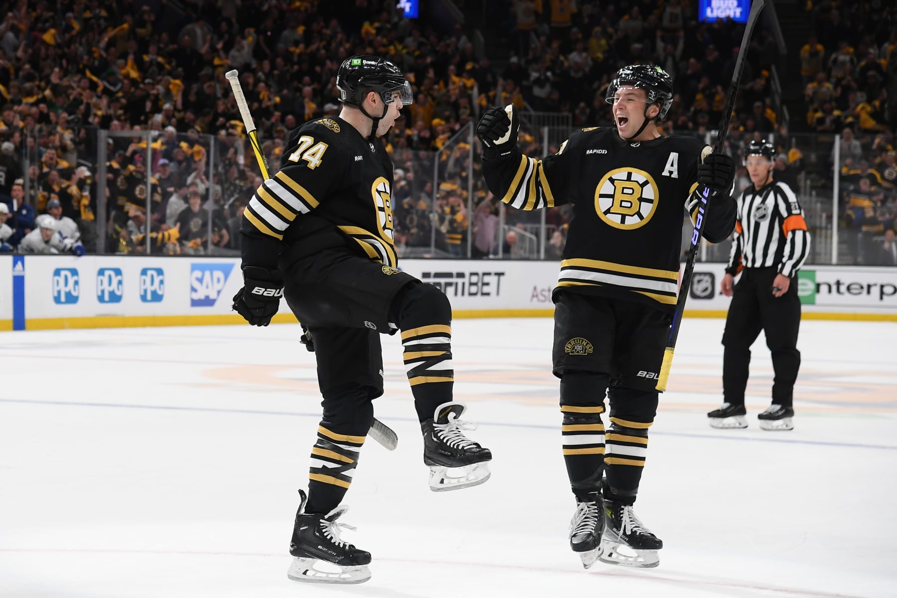 BOSTON, MASSACHUSETTS - APRIL 20: Jake DeBrusk #74 and Charlie McAvoy #73 of the Boston Bruins celebrate the second-period goal against the Toronto Maple Leafs in Game One of the First Round of the 2024 Stanley Cup Playoffs at the TD Garden on April 20, 2024 in Boston, Massachusetts. (Photo by Steve Babineau/NHLI via Getty Images)