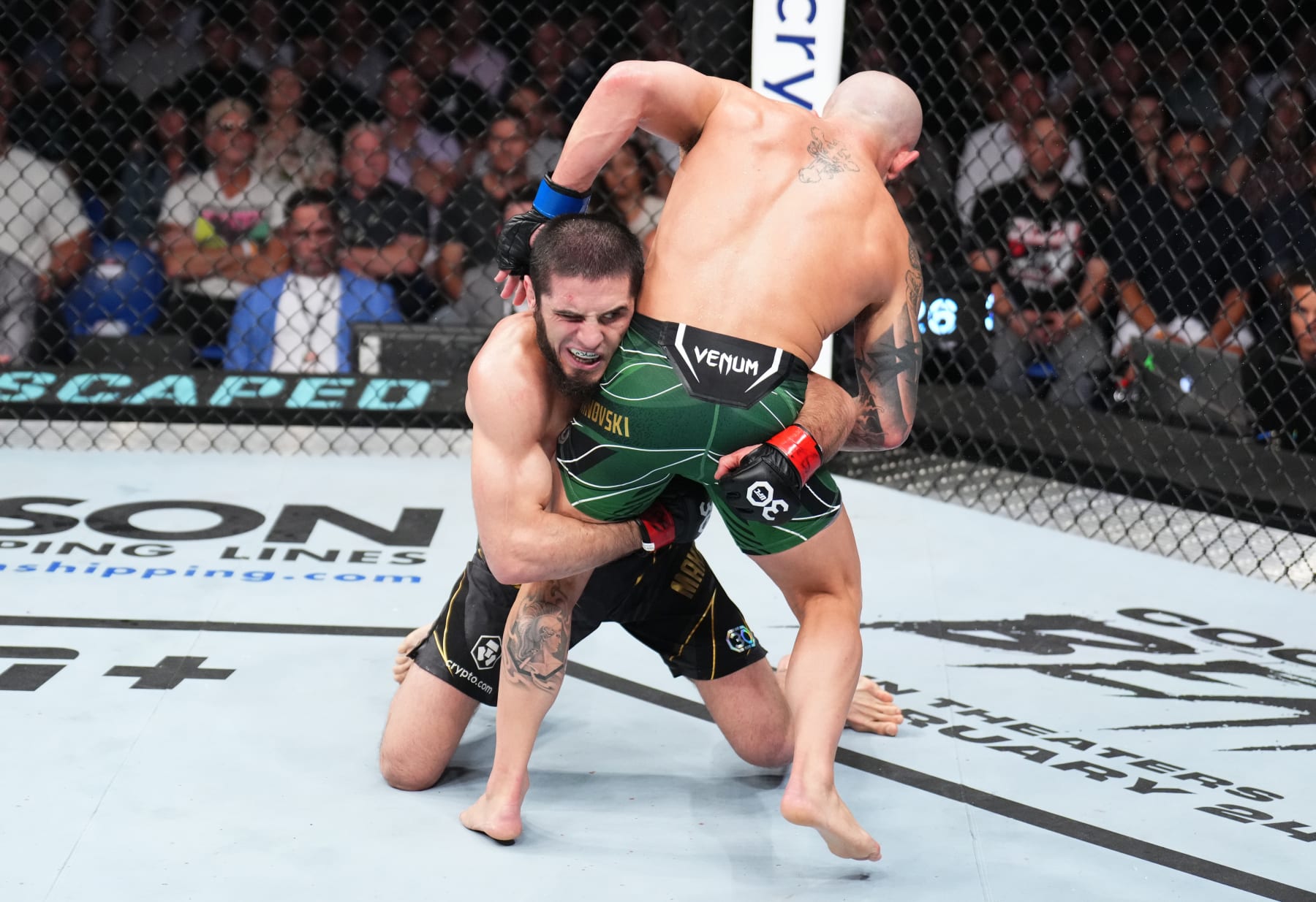 Islam Makhachev shoots for a takedown against Alexander Volkanovski.