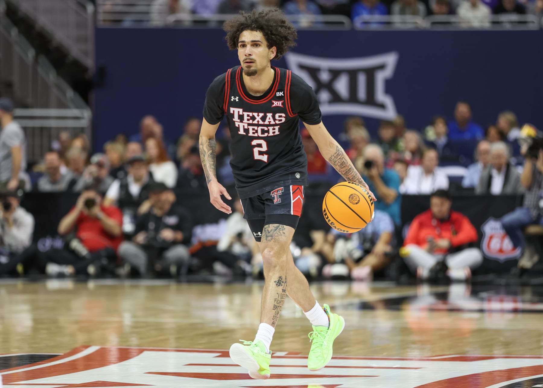 KANSAS CITY, MO - MARCH 15: Texas Tech Red Raiders guard Pop Isaacs (2) brings the ball up court in the first half of a Big 12 tournament semifinal game between the Texas Tech Red Raiders and Houston Cougars on Mar 15, 2024 at T-Mobile Center in Kansas City, MO. (Photo by Scott Winters/Icon Sportswire via Getty Images)