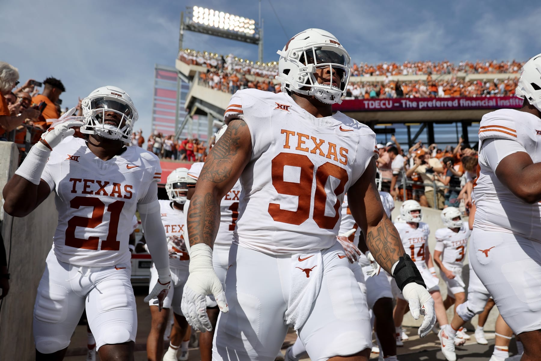 HOUSTON, TEXAS - OCTOBER 21: Byron Murphy II #90 of the Texas Longhorns and Kitan Crawford #21 take the field before the game against the Houston Cougars at TDECU Stadium on October 21, 2023 in Houston, Texas. (Photo by Tim Warner/Getty Images)
