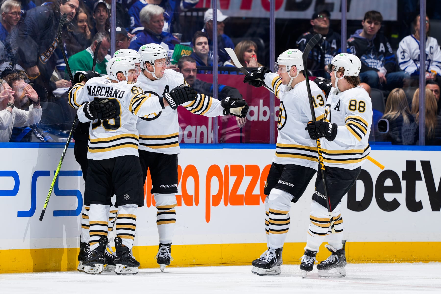 TORONTO, ON - APRIL 24: Jake DeBrusk #74 of the Boston Bruins celebrates his goal against the Toronto Maple Leafs with teammates Brad Marchand #63, Charlie Coyle #13 and David Pastrnak #88 during the third period in Game Three of the First Round of the 2024 Stanley Cup Playoffs at Scotiabank Arena on April 24, 2024 in Toronto, Ontario, Canada. (Photo by Mark Blinch/NHLI via Getty Images)