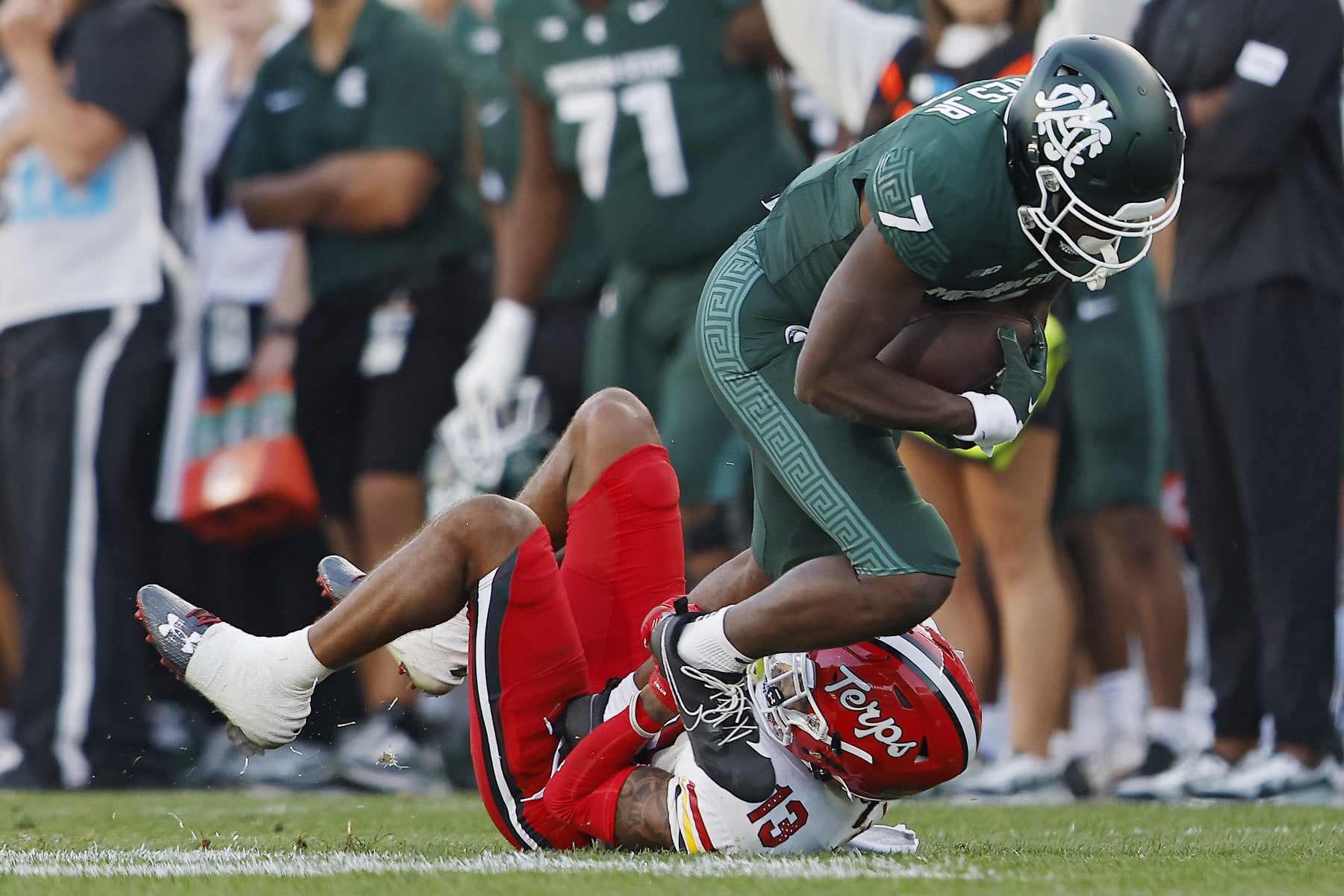EAST LANSING, MICHIGAN - SEPTEMBER 23: Antonio Gates Jr. #7 of the Michigan State Spartans catches a pass against Glendon Miller #13 of the Maryland Terrapins in the fourth quarter of a game at Spartan Stadium on September 23, 2023 in East Lansing, Michigan. (Photo by Mike Mulholland/Getty Images)