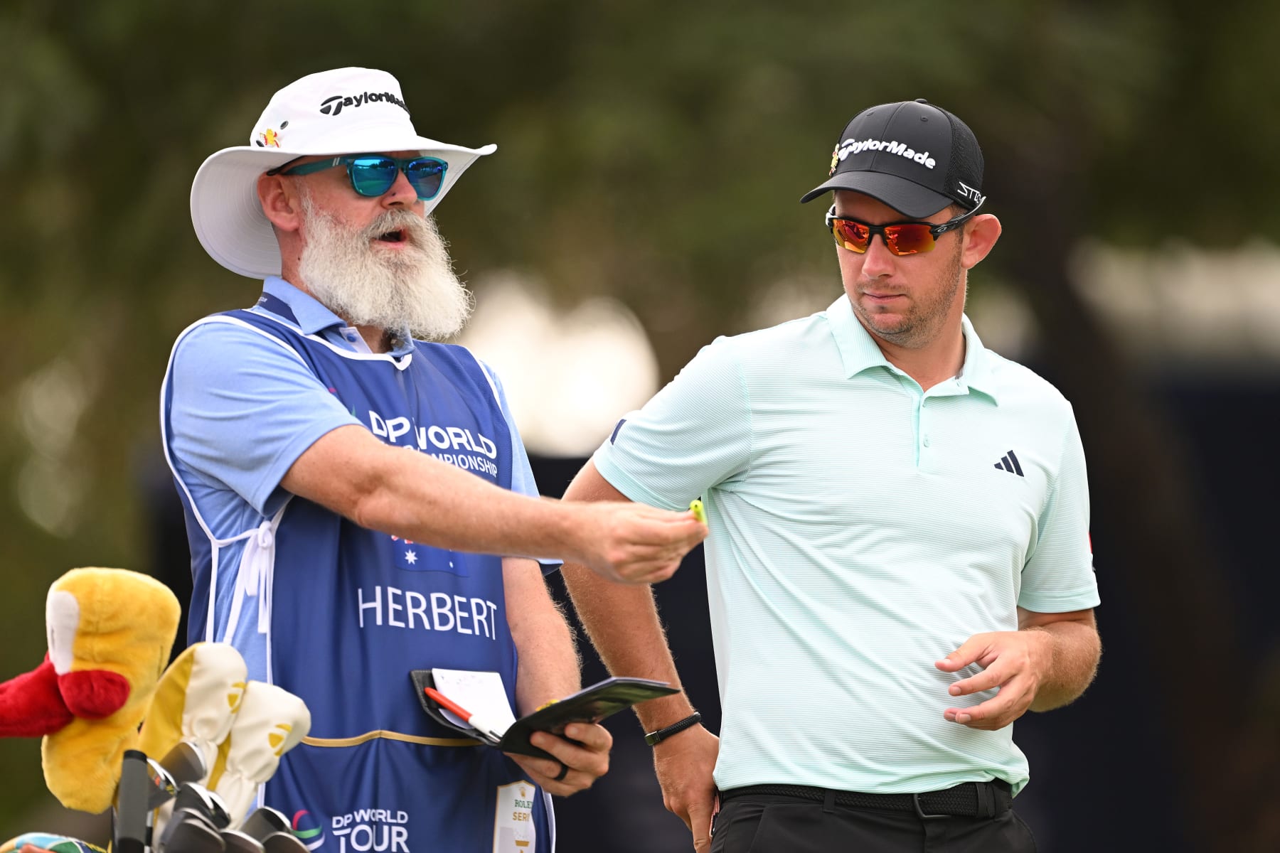 DUBAI, UNITED ARAB EMIRATES - NOVEMBER 16: Lucas Herbert of Australia looks across the fourth hole with his caddie, Nick Pugh during Day One of the DP World Tour Championship on the Earth Course at Jumeirah Golf Estates on November 16, 2023 in Dubai, United Arab Emirates. (Photo by Ross Kinnaird/Getty Images)
